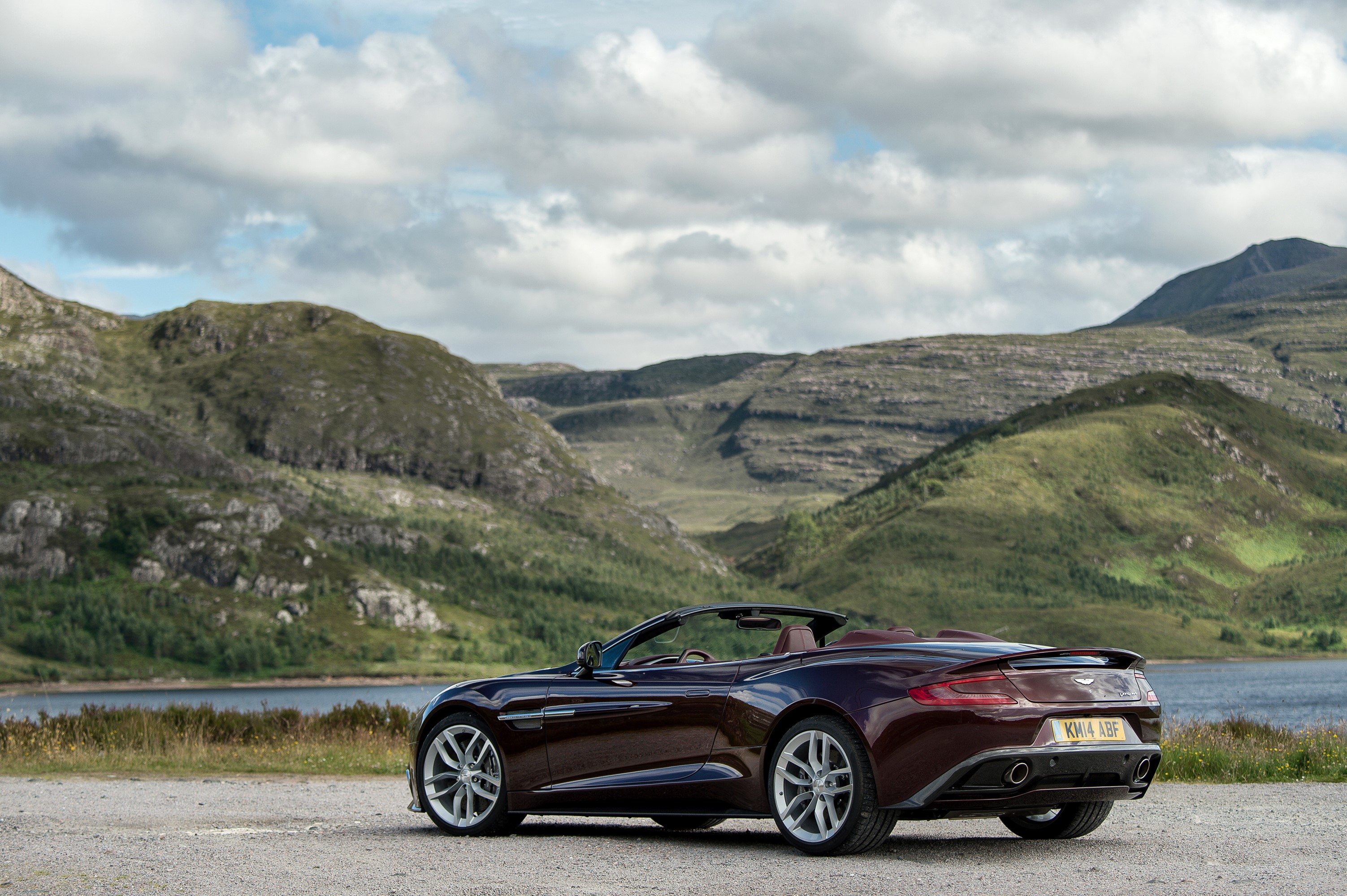 Aston Martin Vanquish Volante convertible in a mountainous landscape HD Wallpaper