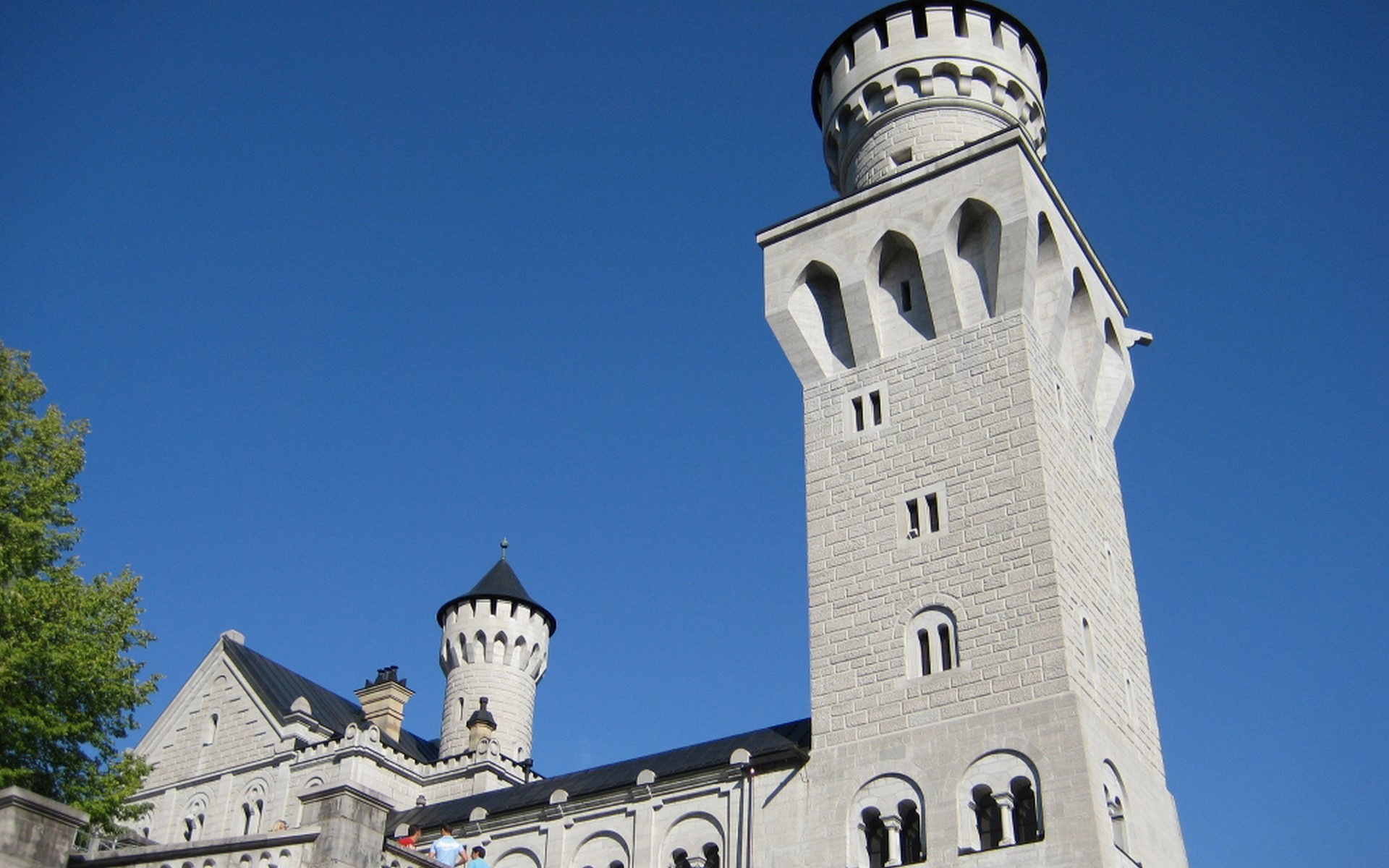 Neuschwanstein Castle towers against a blue sky HD Wallpaper