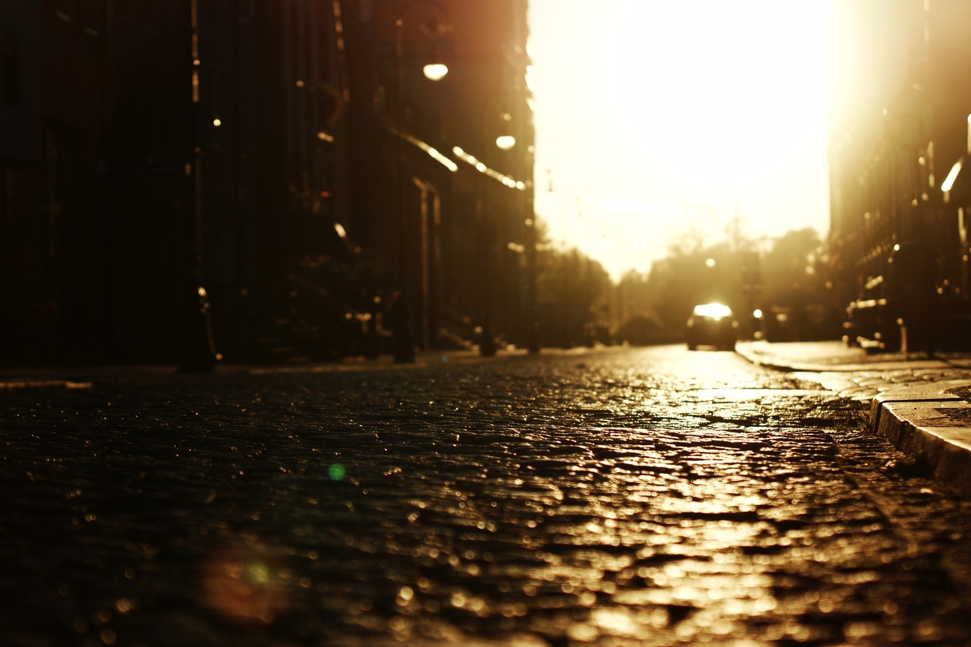 Street with cobblestones and car at sunset HD Wallpaper