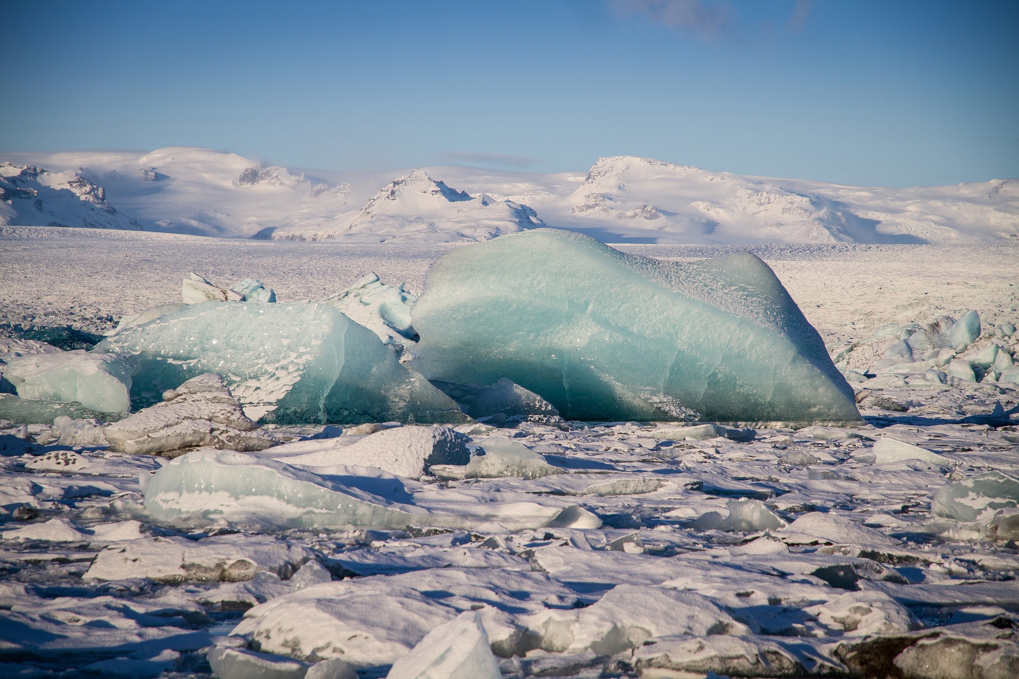 Icebergs and snow-covered mountains under a blue sky HD Wallpaper