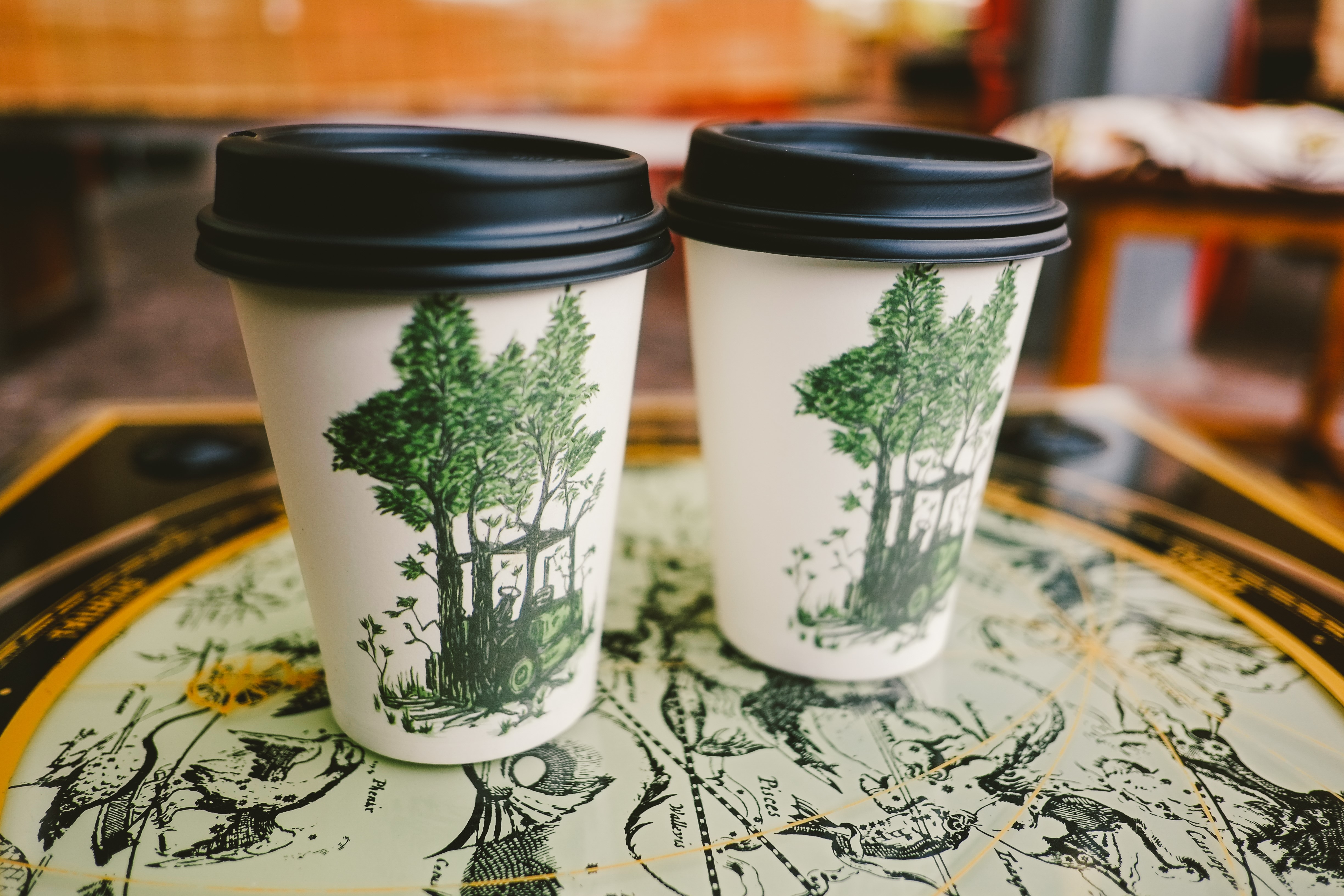 Two coffee cups with tree design HD Wallpaper