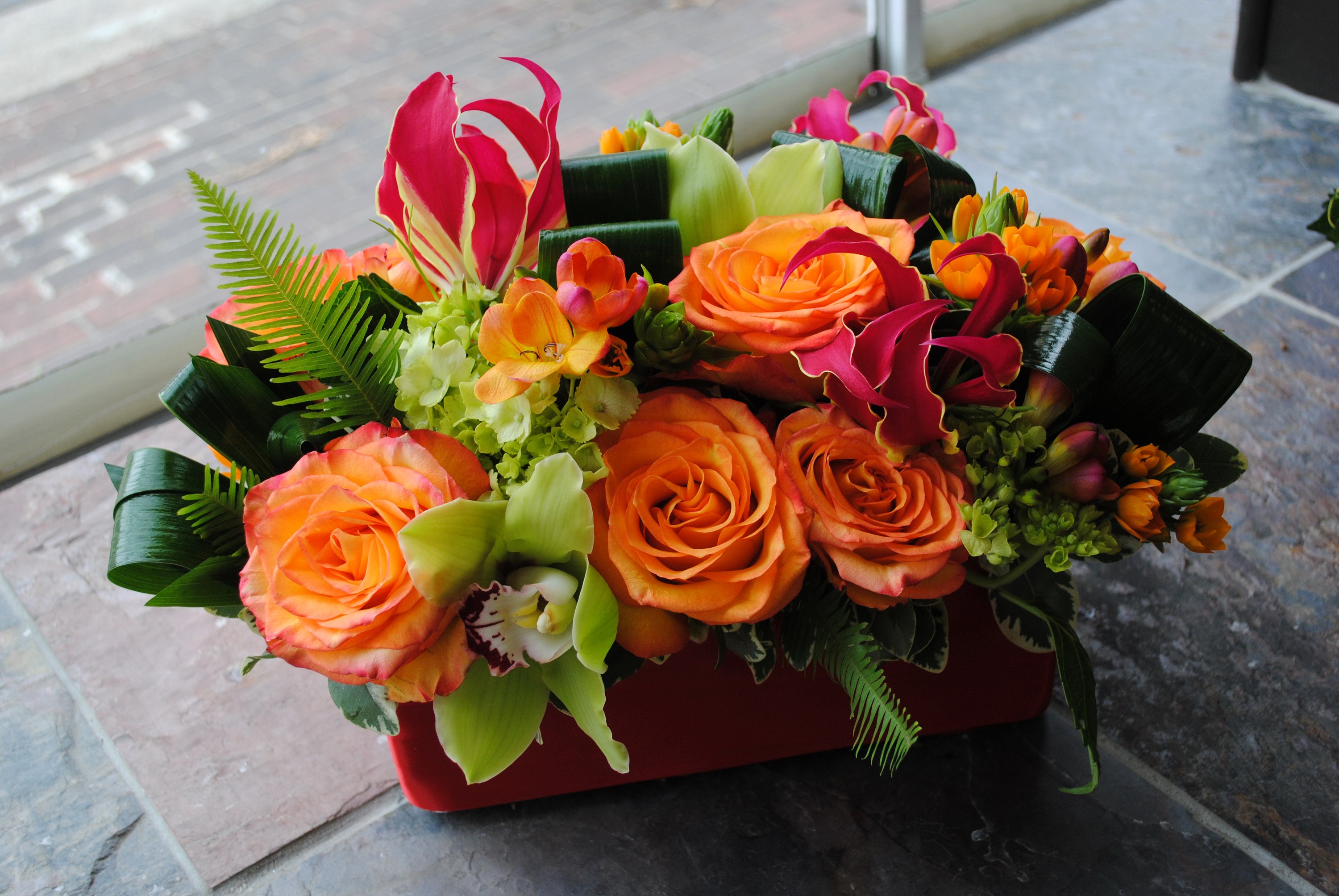 Orange Roses and Orchids in a Red Vase HD Wallpaper