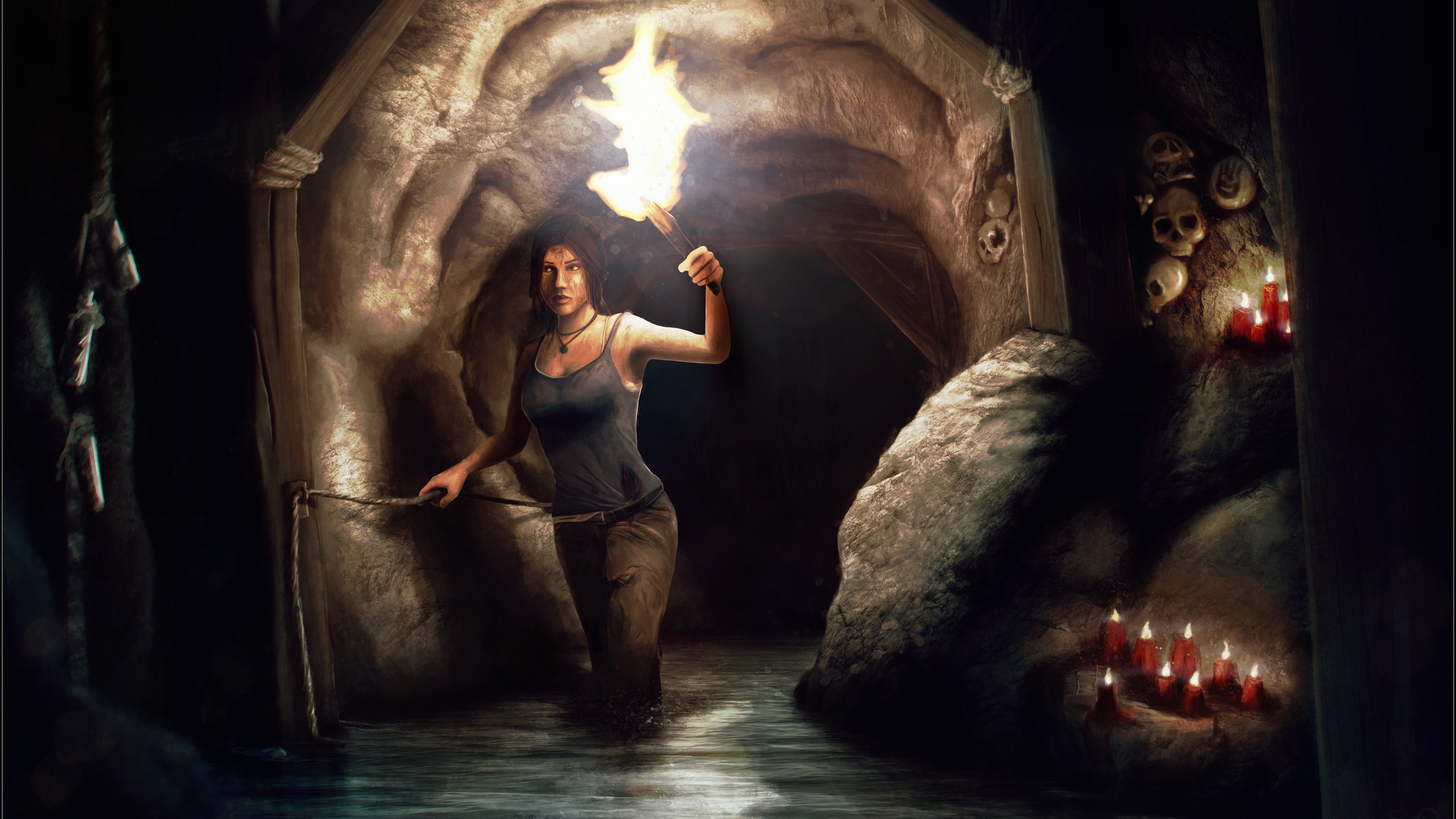 Lara Croft from Tomb Raider holding a torch in a cave HD Wallpaper
