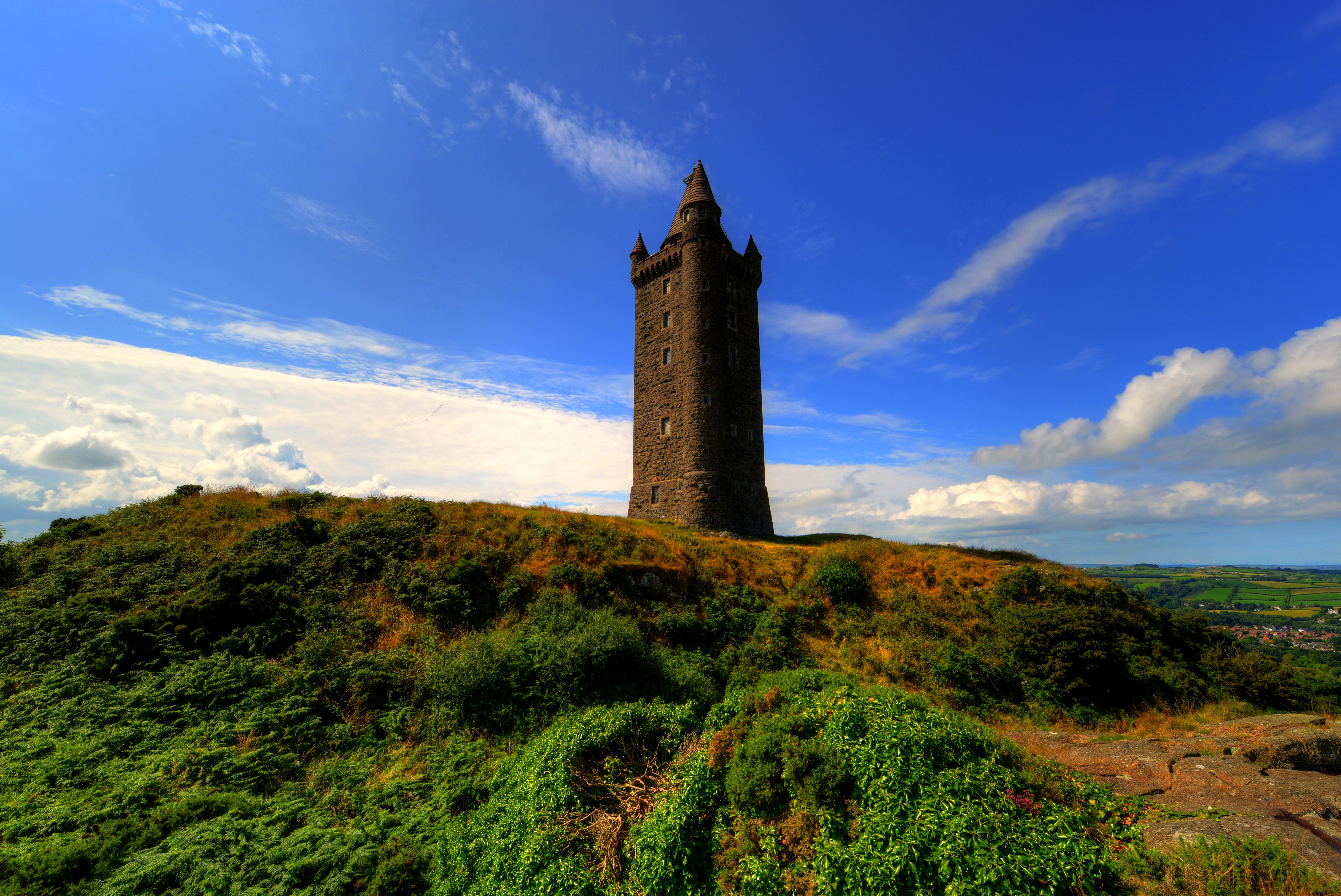 Scrabo Tower on a grassy hill under a blue sky HD Wallpaper