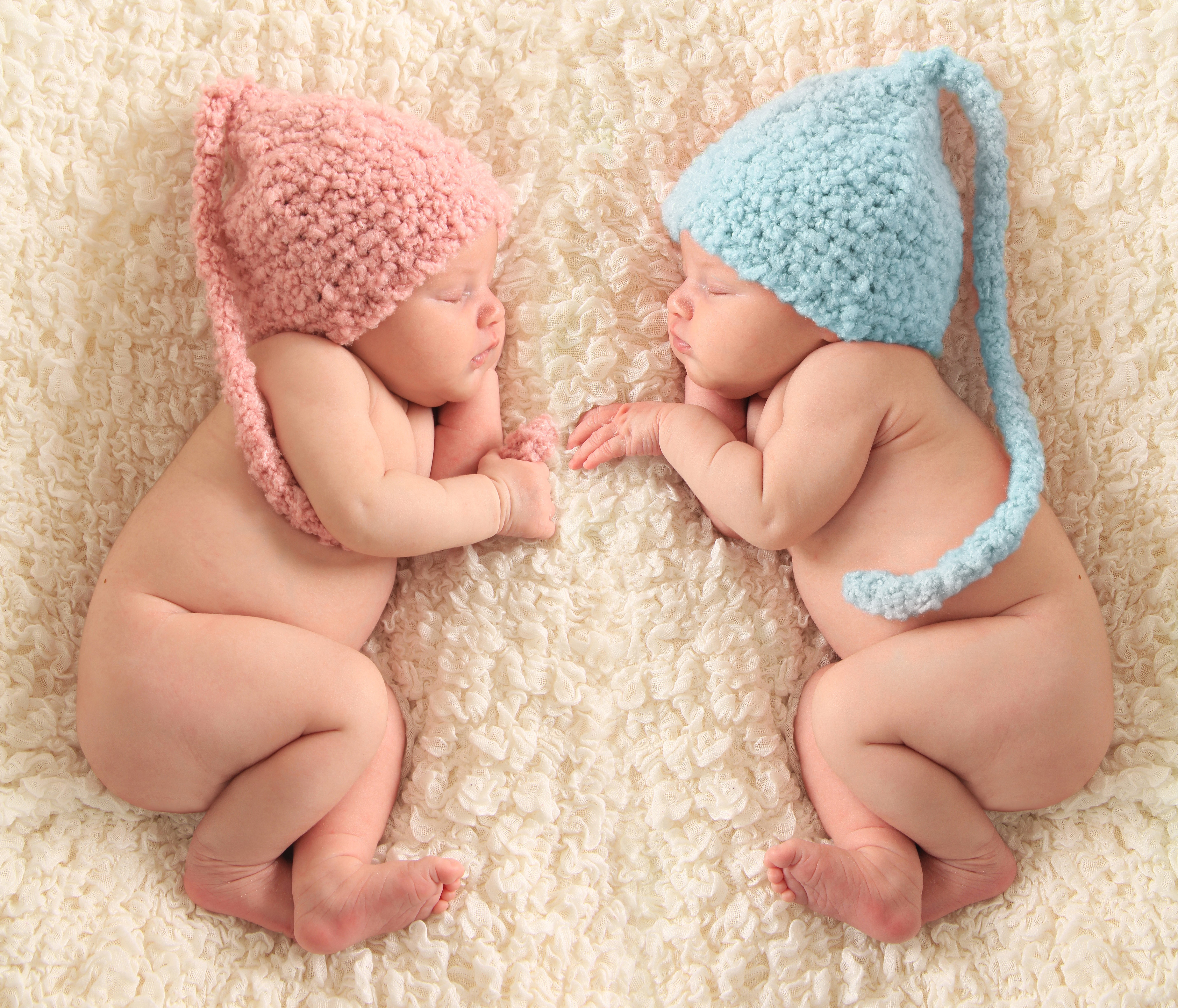 Two infants sleeping in winter hats HD Wallpaper