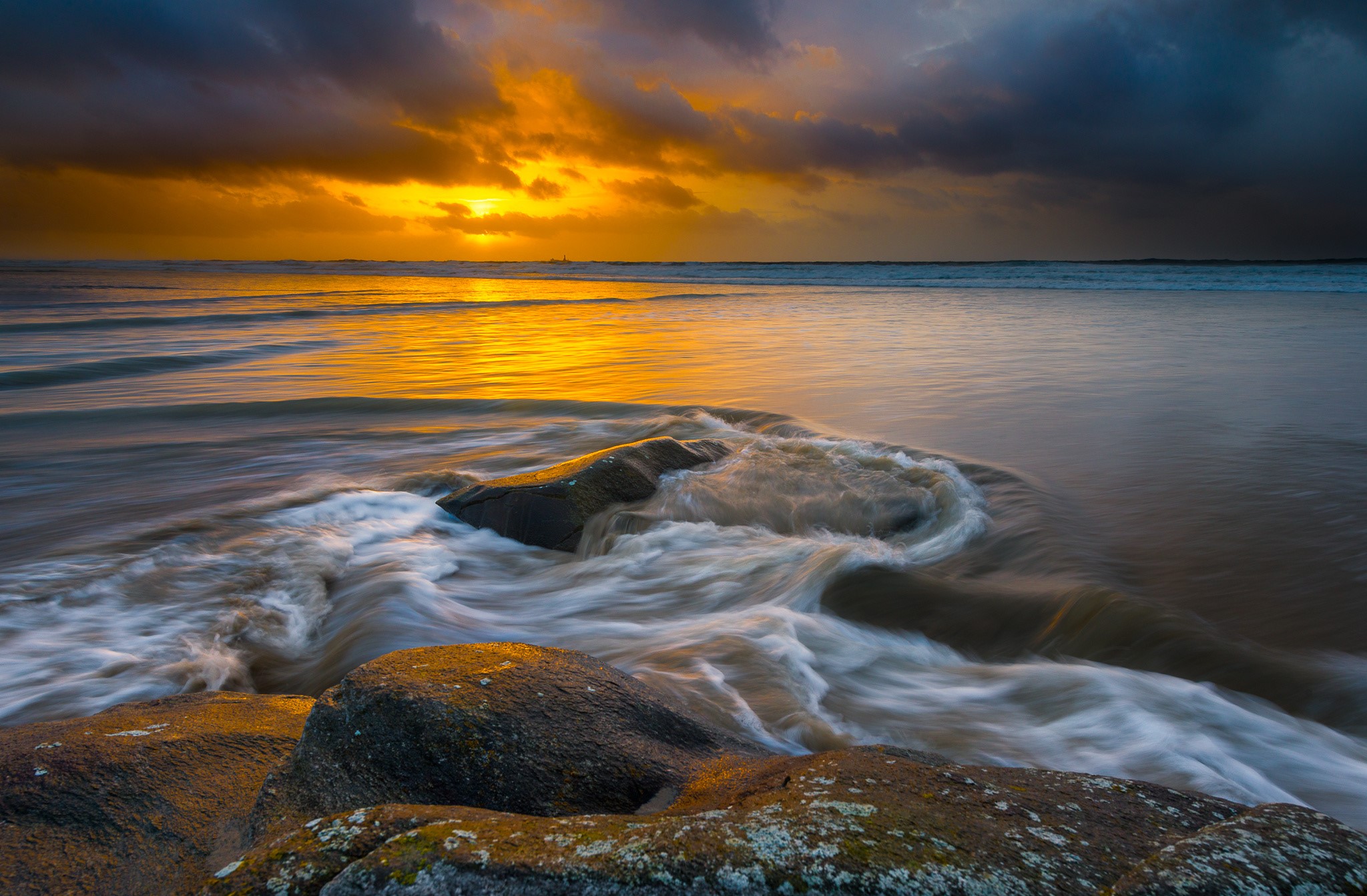 Sunset over Hellesto Beach, Stavanger, Norway with waves and stones HD Wallpaper