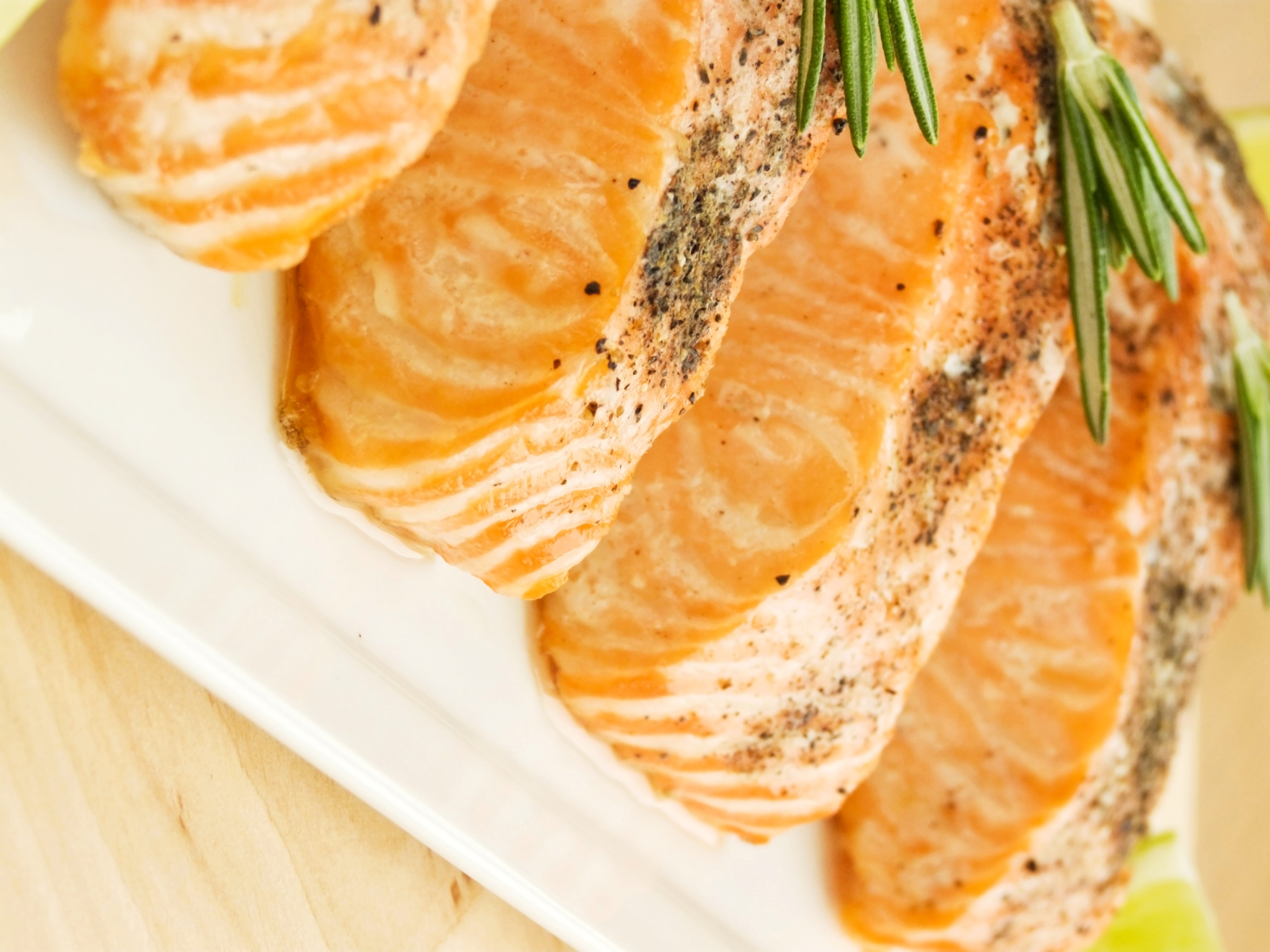 Four pieces of cooked salmon with rosemary HD Wallpaper