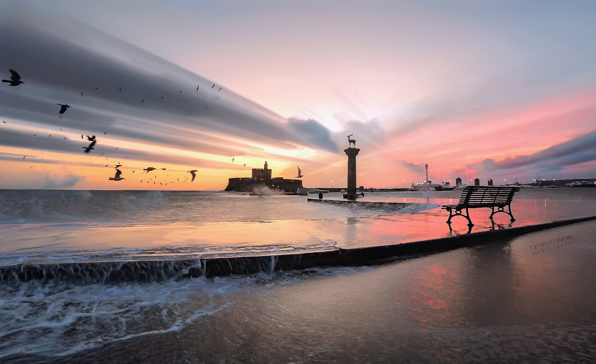 Sunset at the harbor with a statue and castle in Greece HD Wallpaper