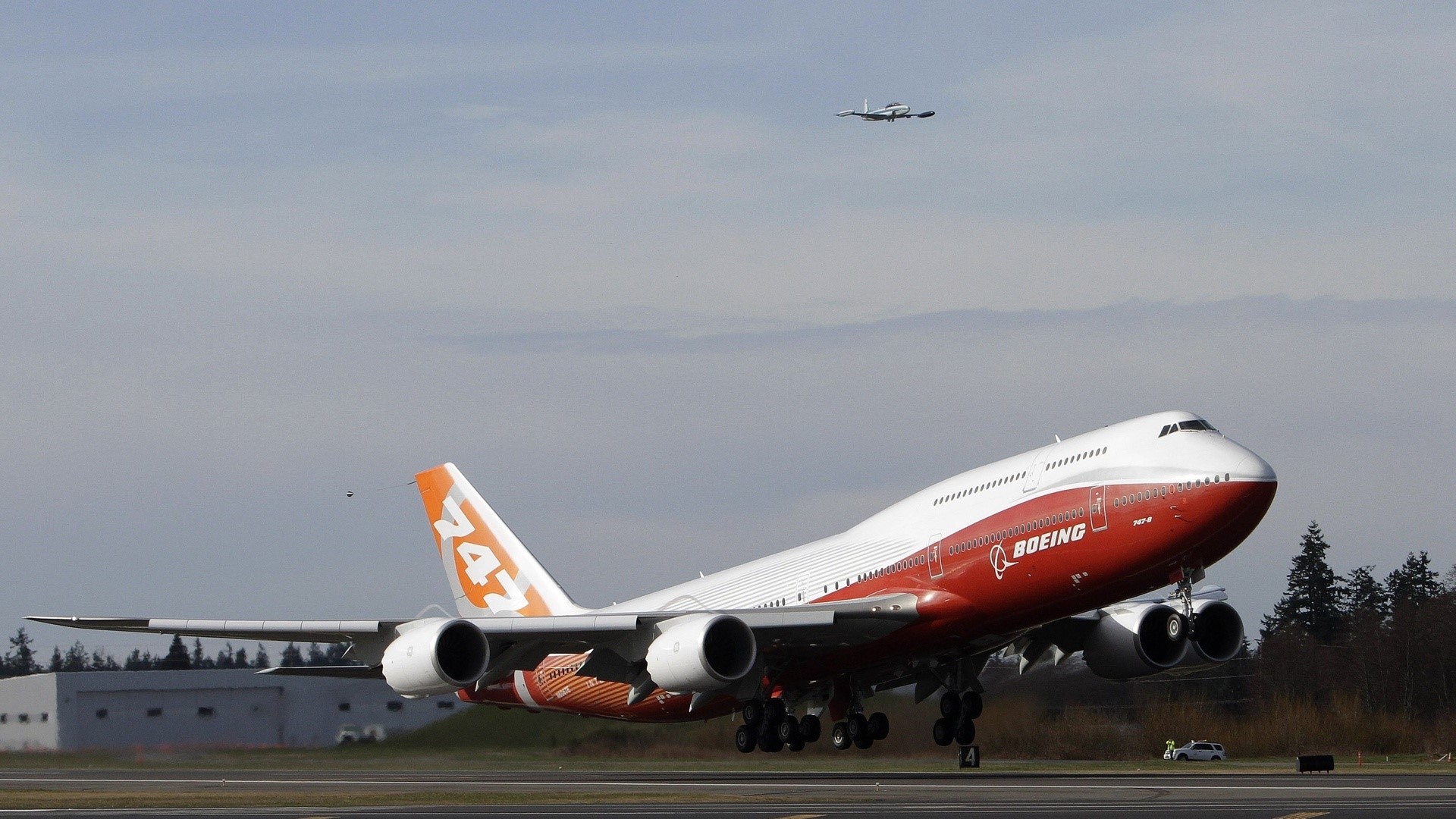 Boeing 747 airplane taking off with another plane in the sky HD Wallpaper