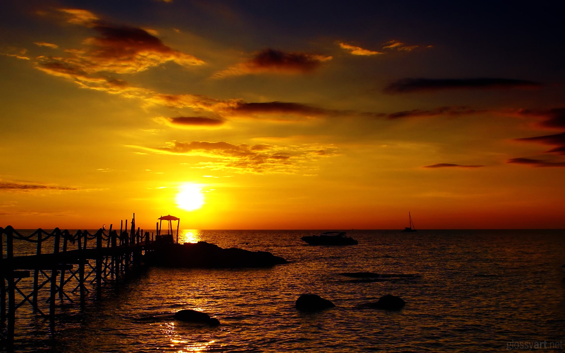 Sunset over the sea with a pier and boats HD Wallpaper