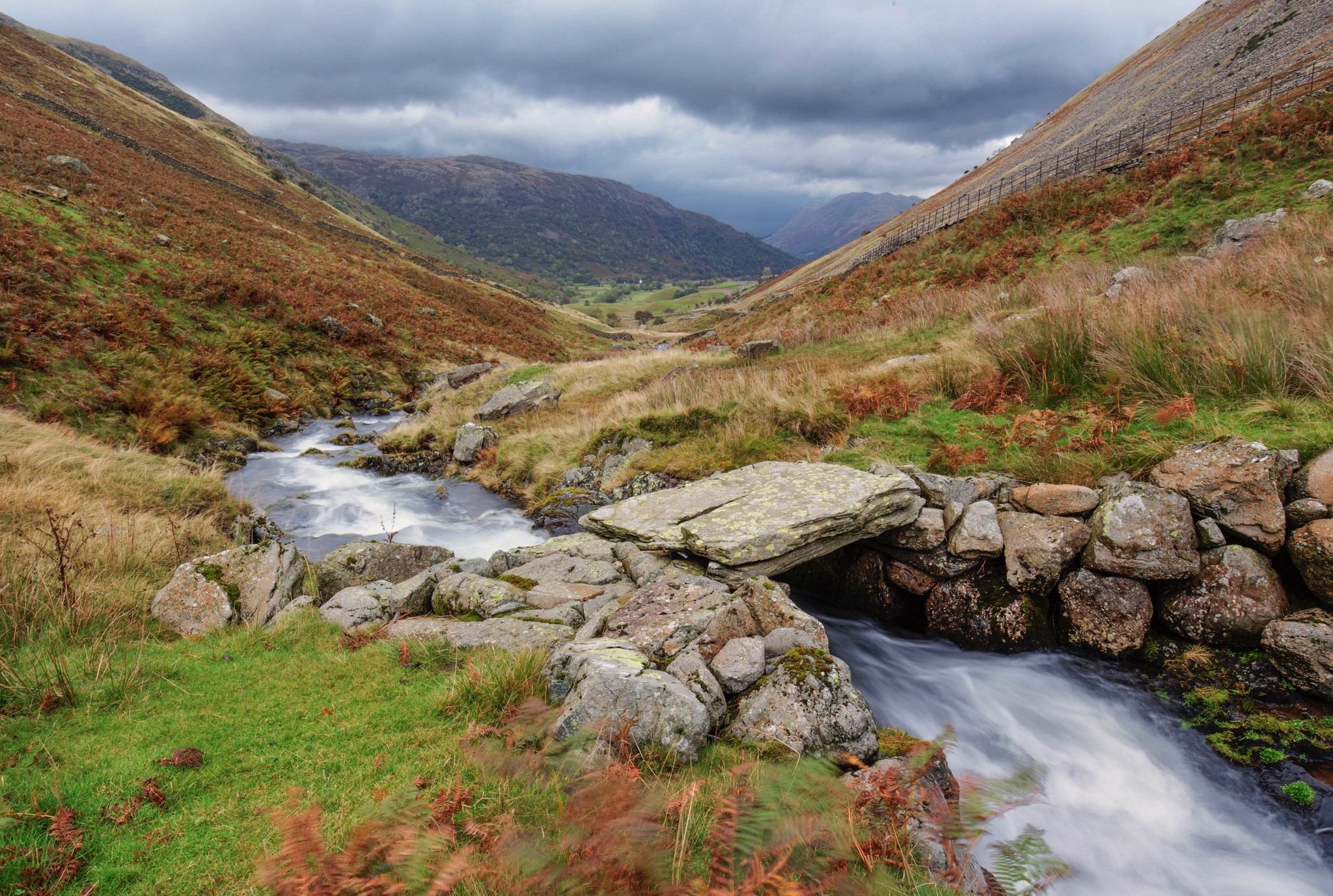 Stone bridge over a stream in a mountain valley HD Wallpaper