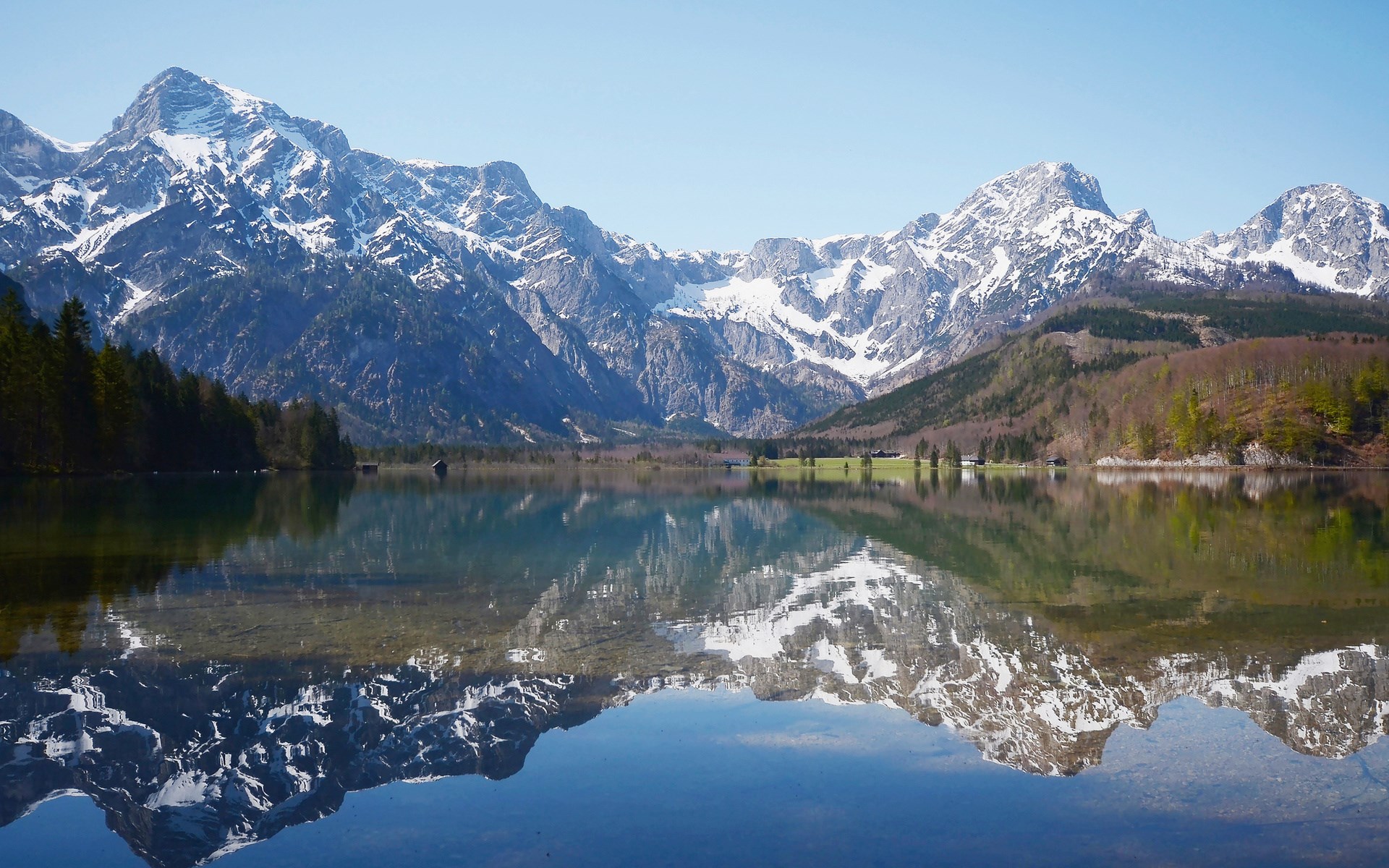 Snow-capped mountains reflected in a calm lake HD Wallpaper