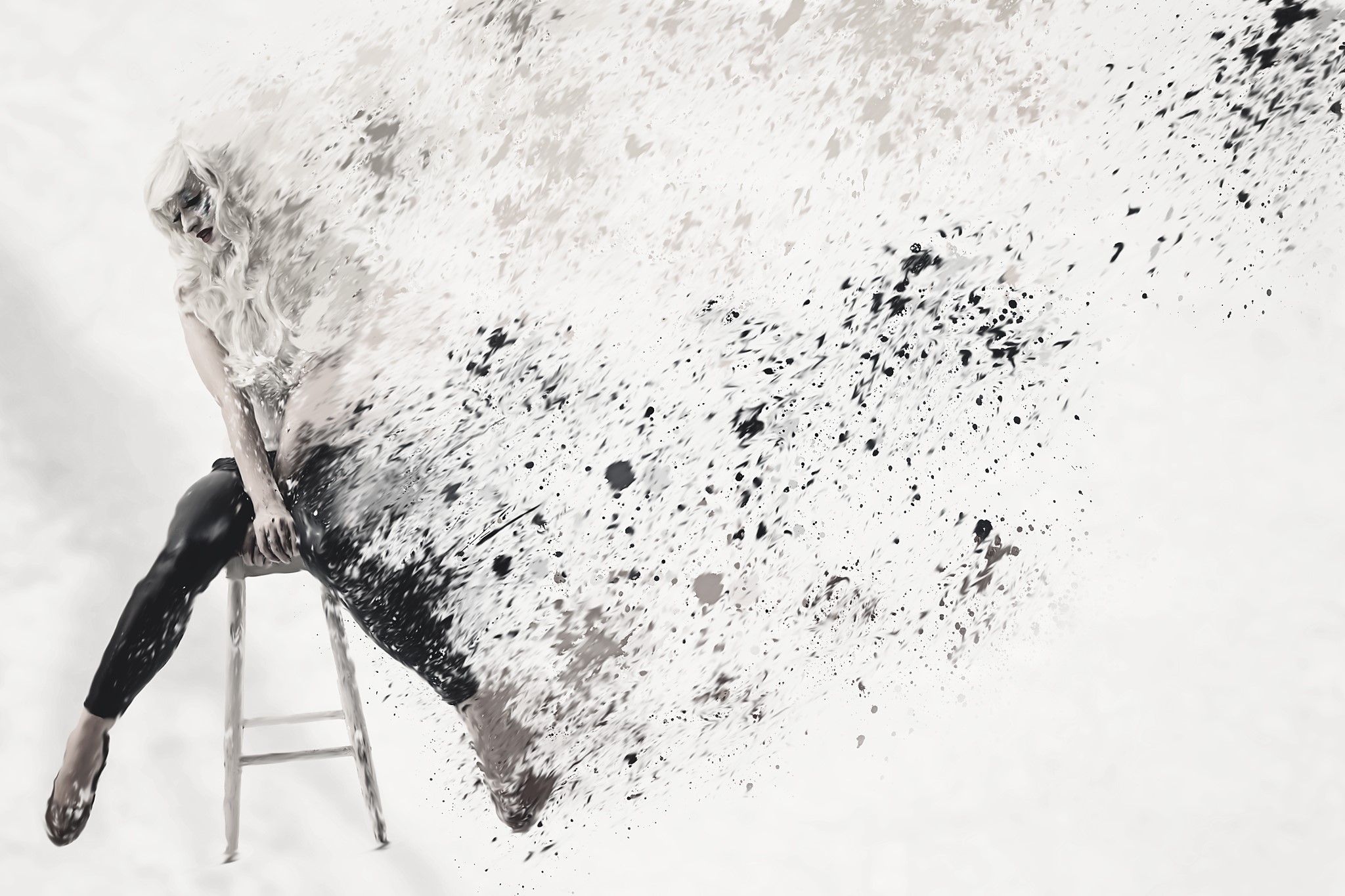 Woman dissolving into paint splatters on a stool HD Wallpaper