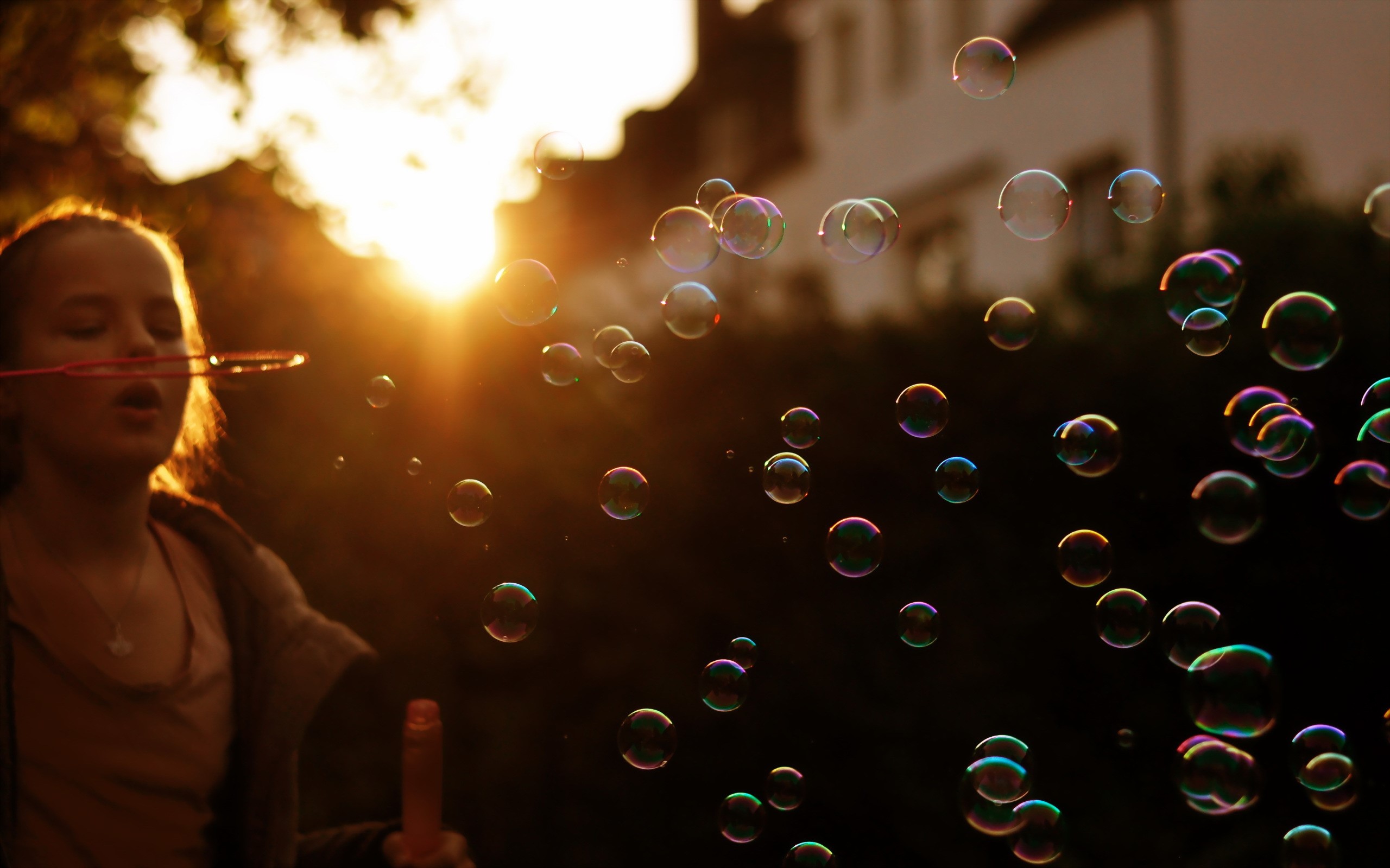 Girl blowing bubbles at sunset HD Wallpaper
