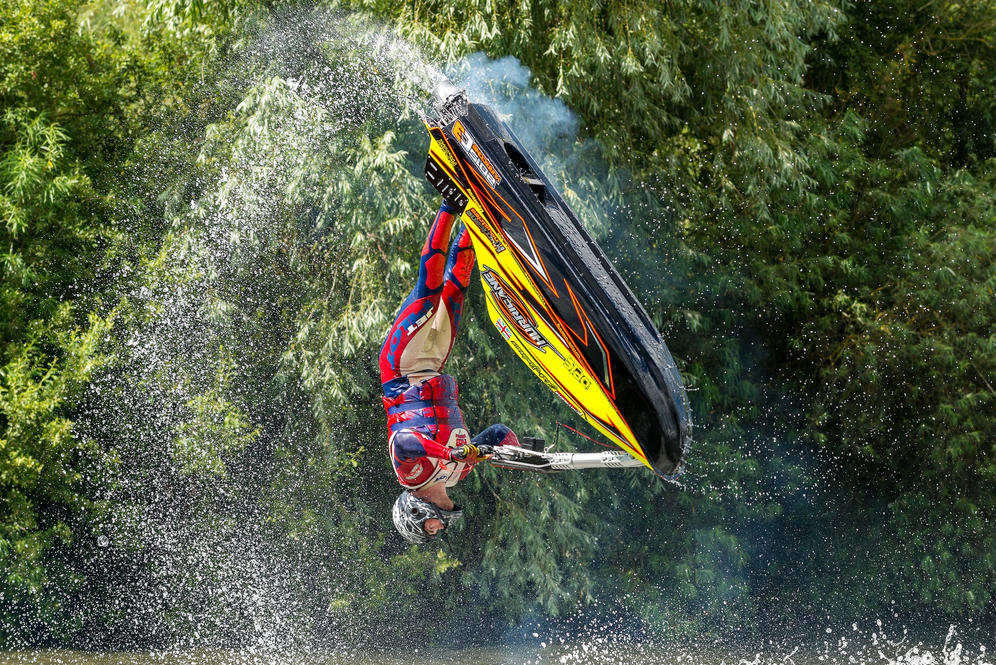 Jet ski rider performing a flip over water HD Wallpaper