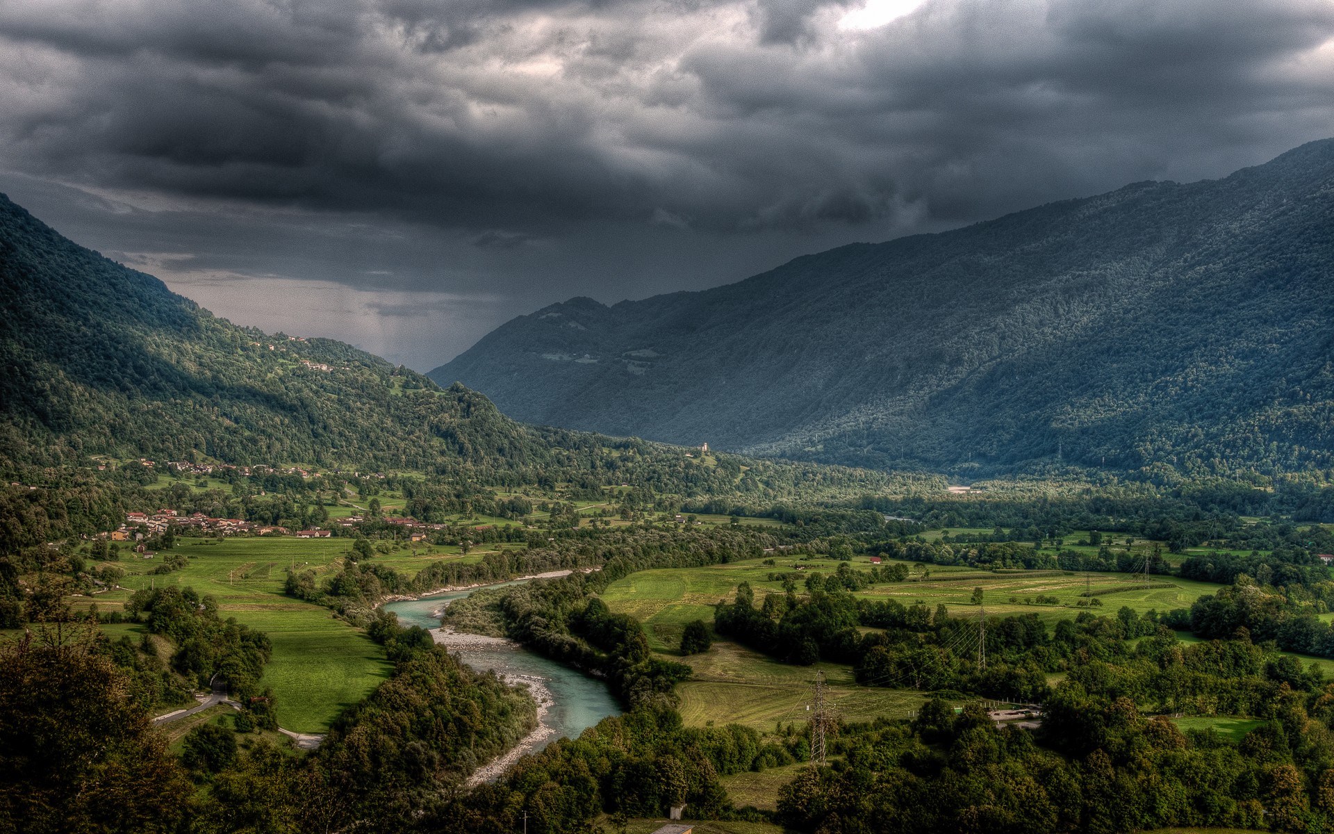 Valley with river and mountains under stormy sky HD Wallpaper