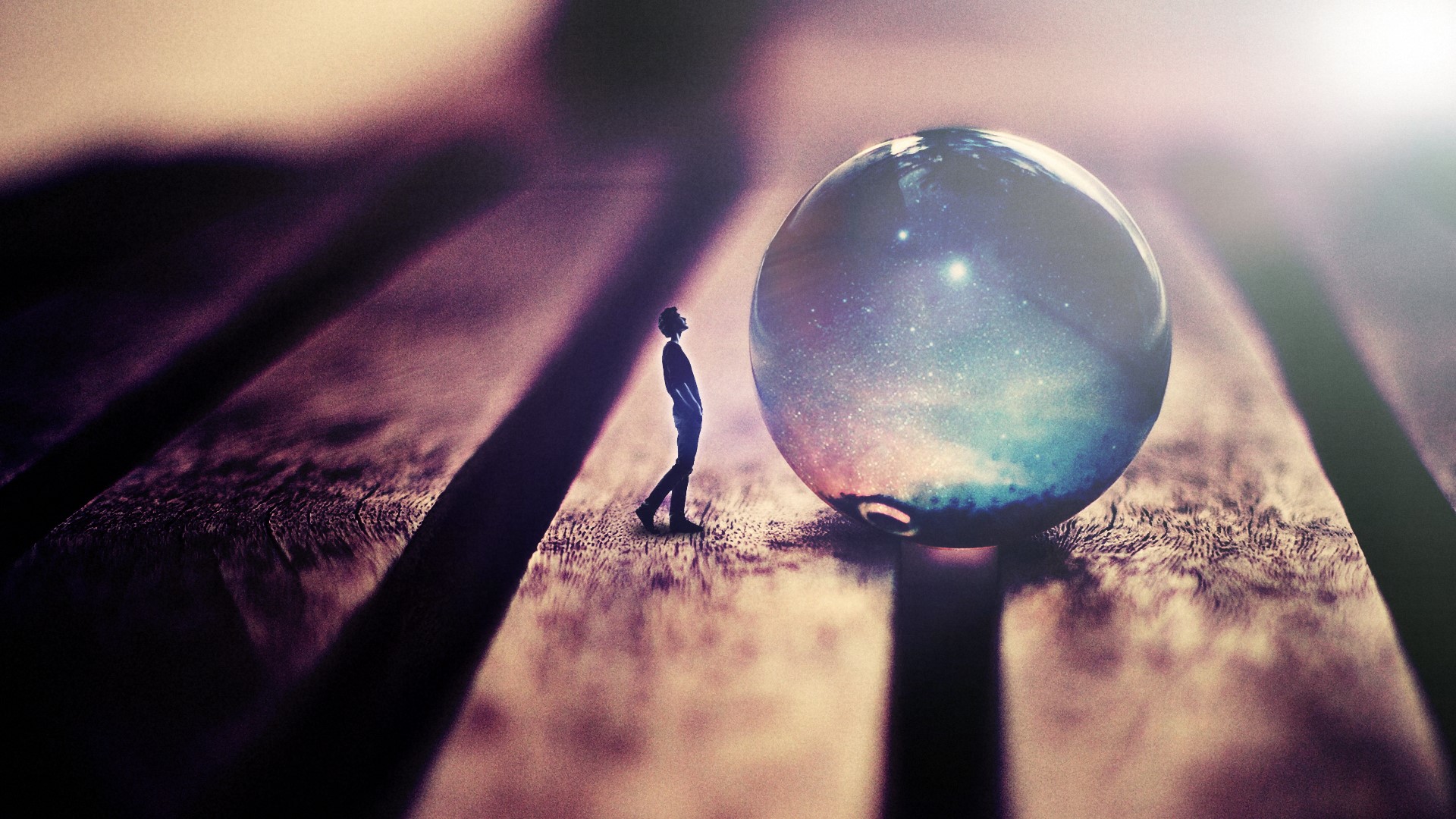Man looking at a galaxy orb on wood planks HD Wallpaper