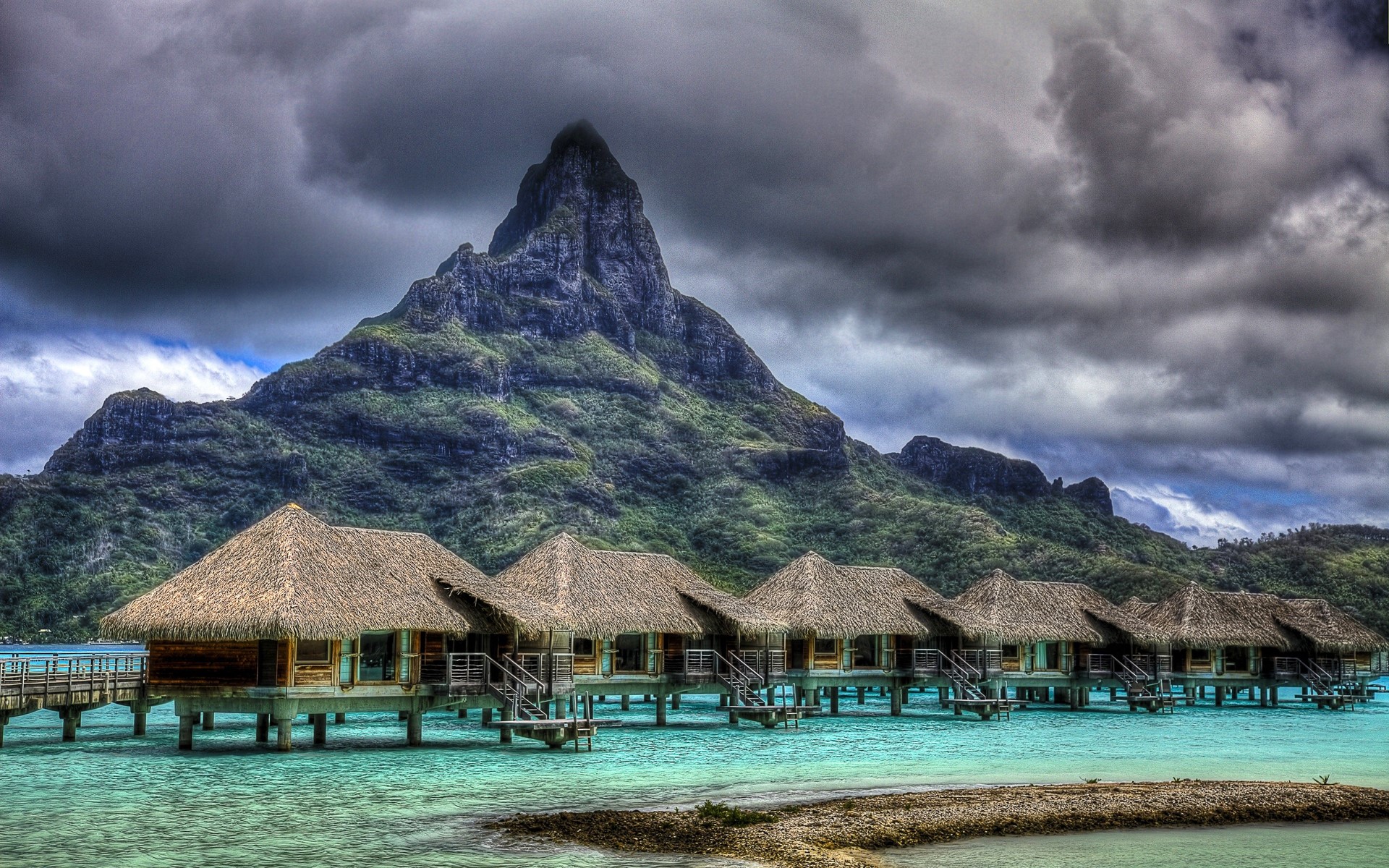 Overwater bungalows with a mountain backdrop HD Wallpaper