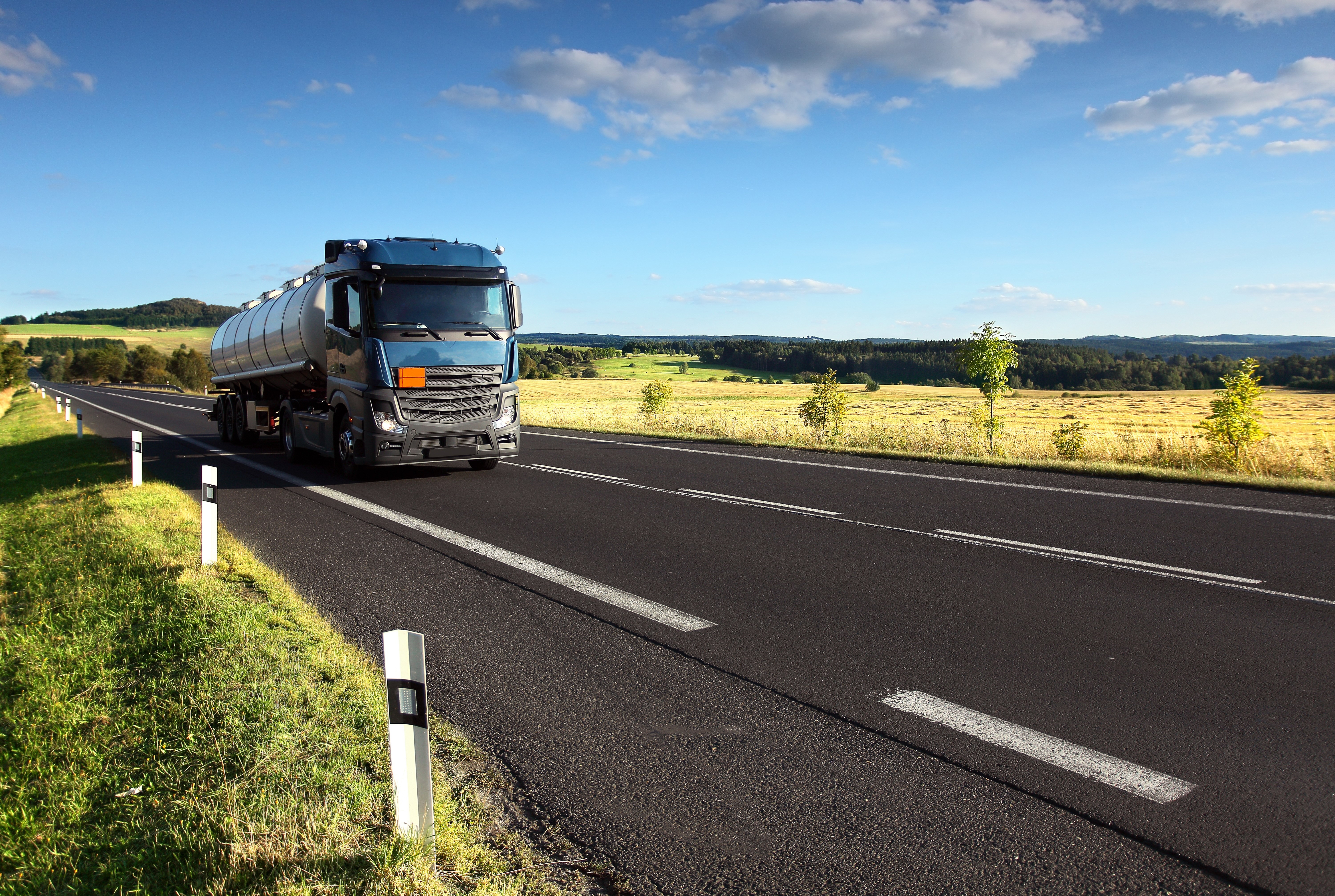 Tanker truck on a rural road HD Wallpaper
