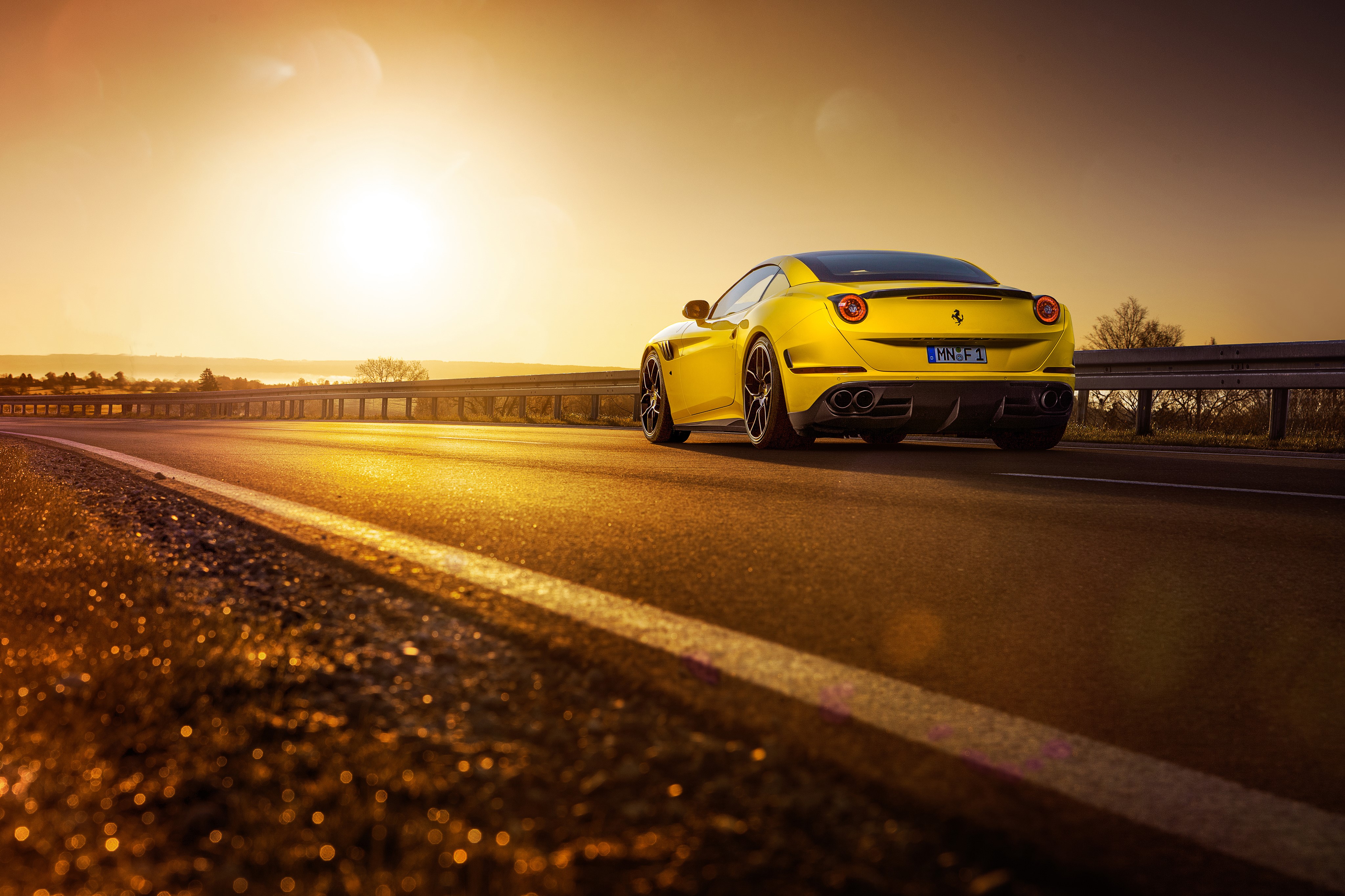 Yellow Ferrari California T on a Road at Sunset HD Wallpaper