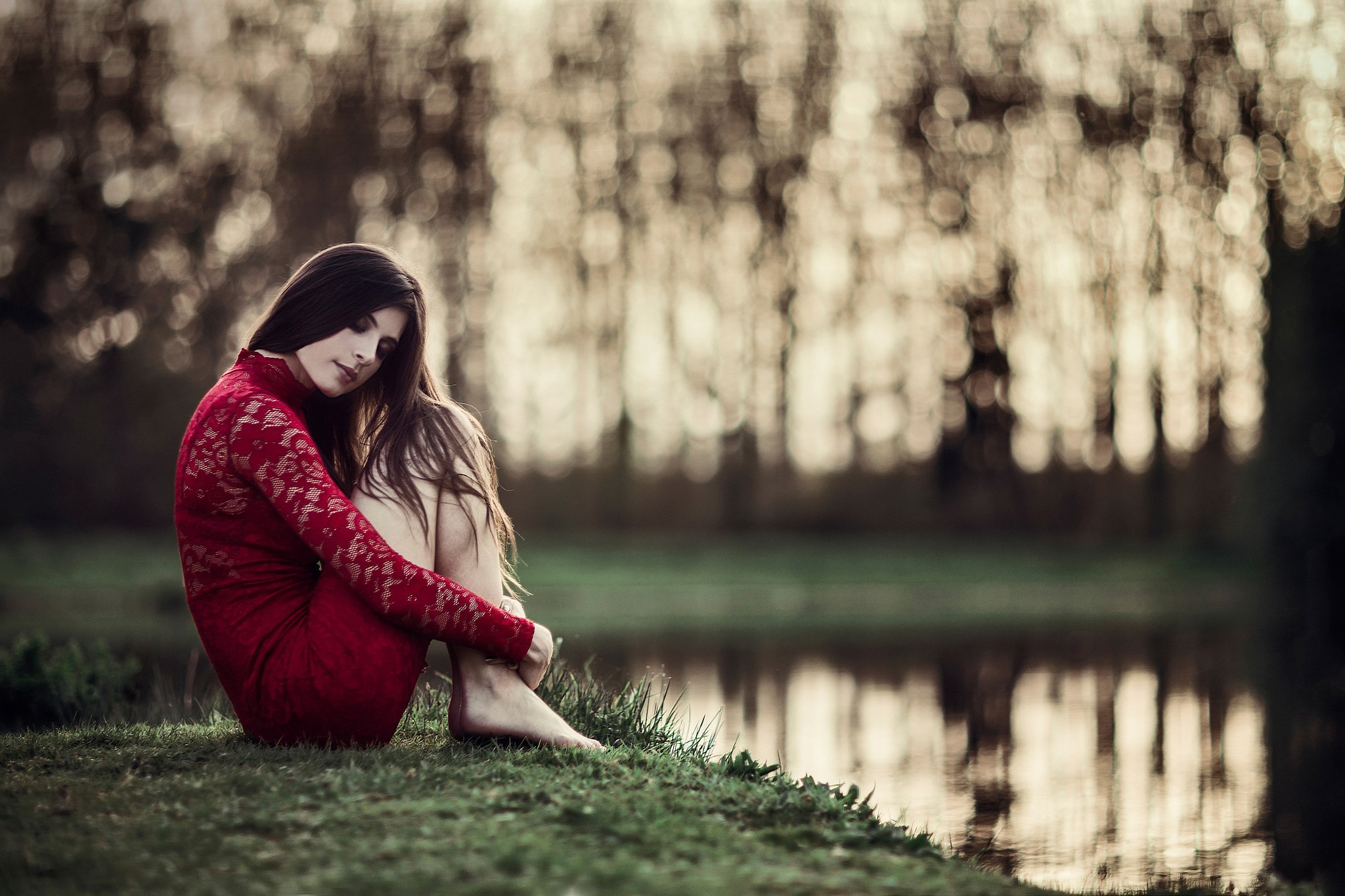 Woman in red dress sitting by a pond HD Wallpaper