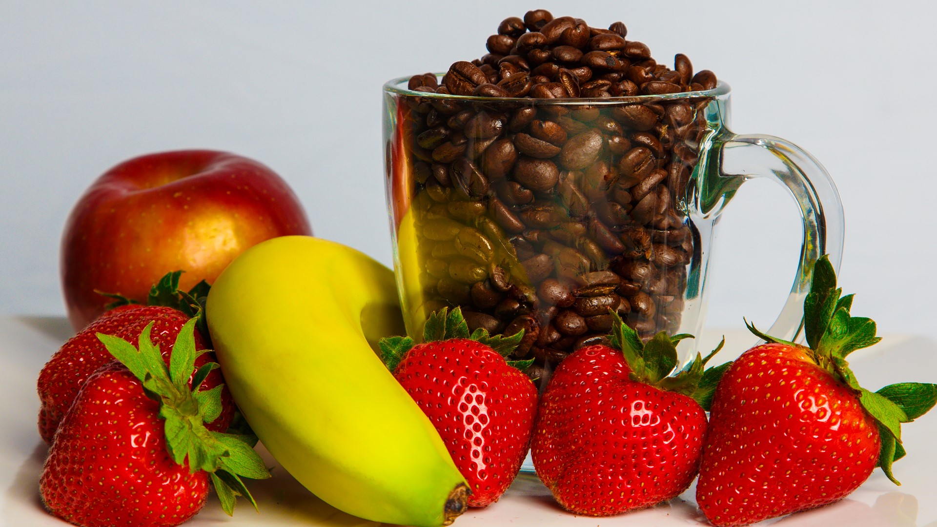 Coffee beans in a mug with fruits HD Wallpaper