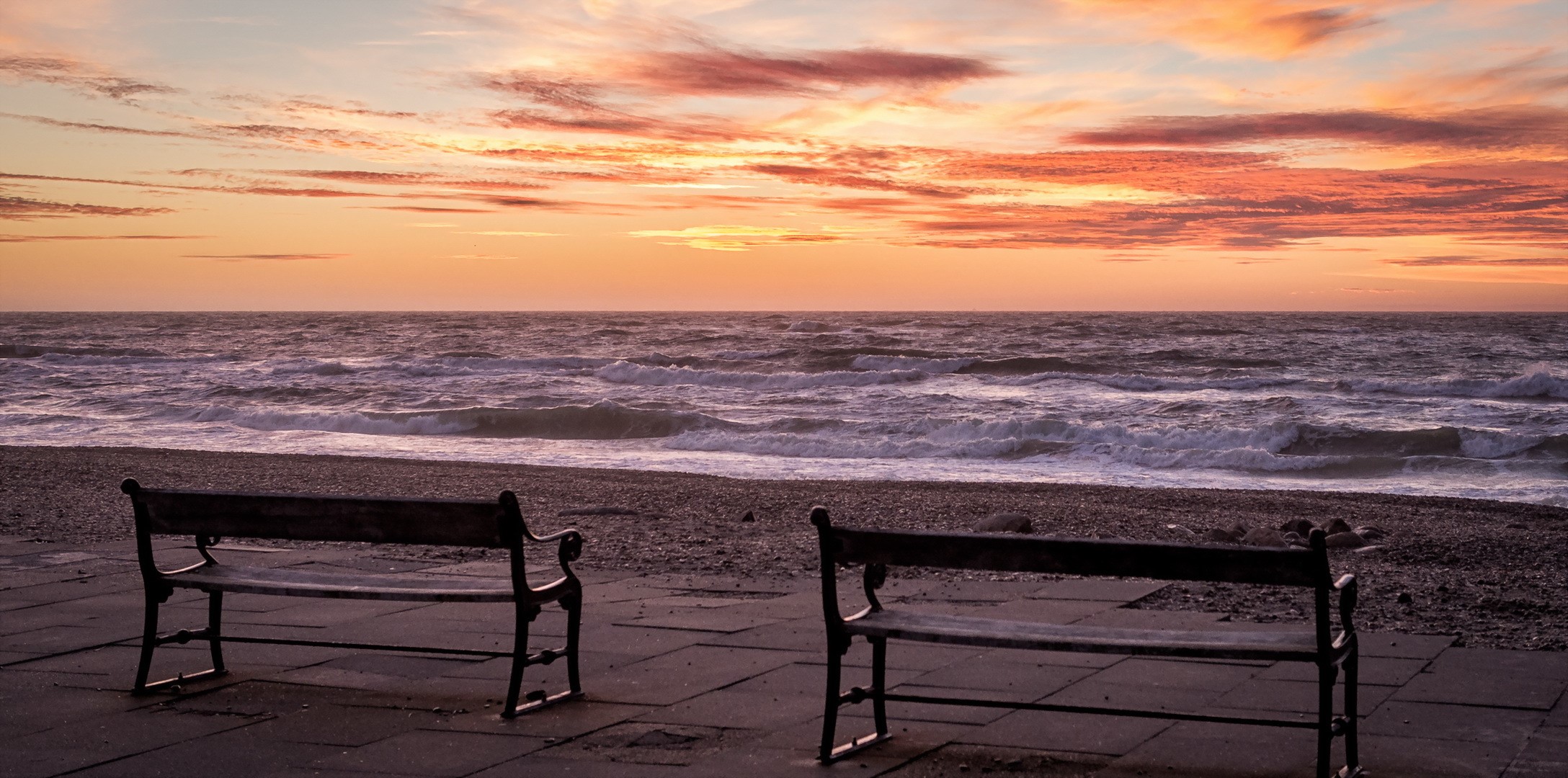 Two benches on a beach at sunset HD Wallpaper