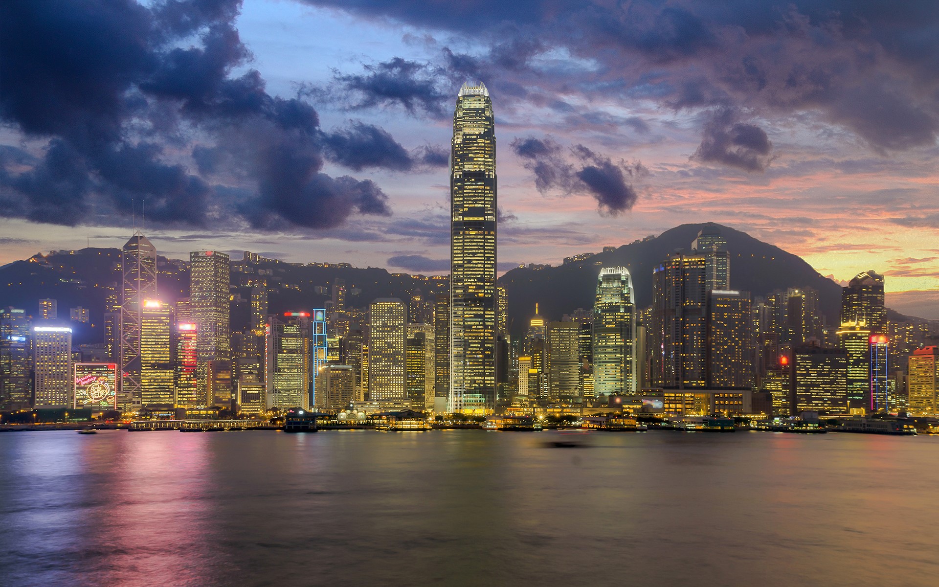 Hong Kong skyline at dusk with mountains and water HD Wallpaper