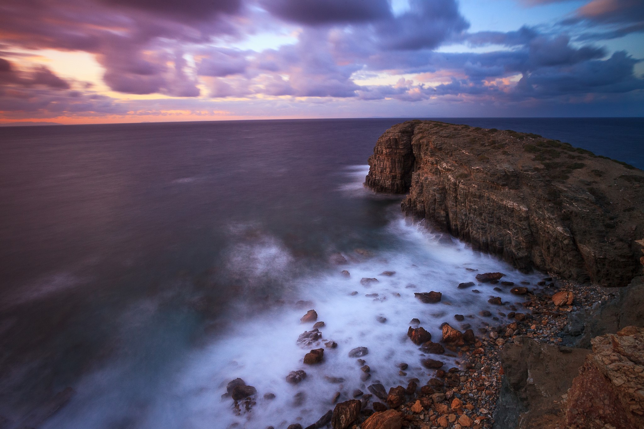 Rocky coast with waves crashing at sunset HD Wallpaper