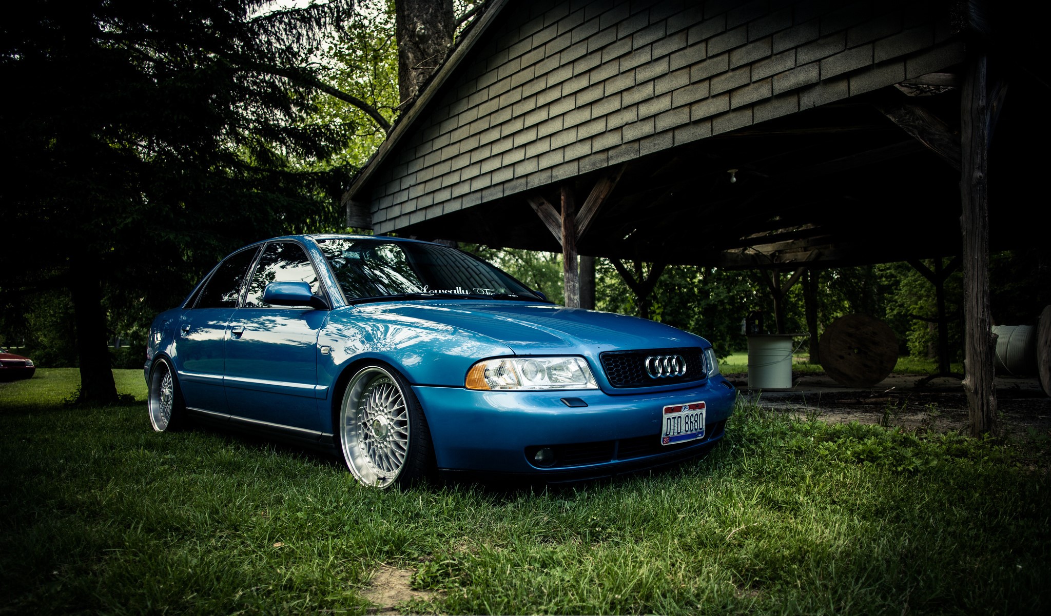 Blue Audi A4 parked under a wooden structure HD Wallpaper