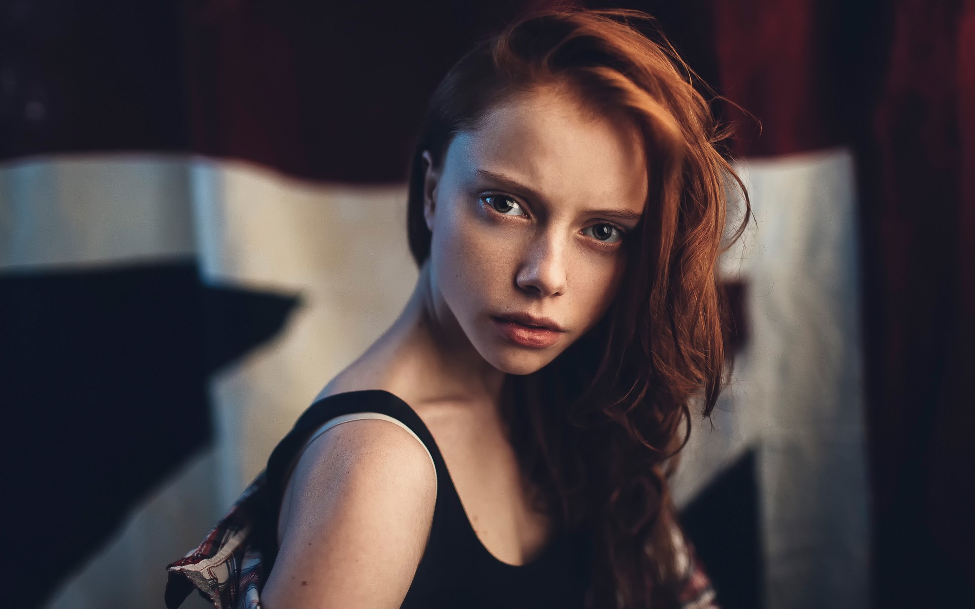 Young woman with red hair looking at the camera HD Wallpaper