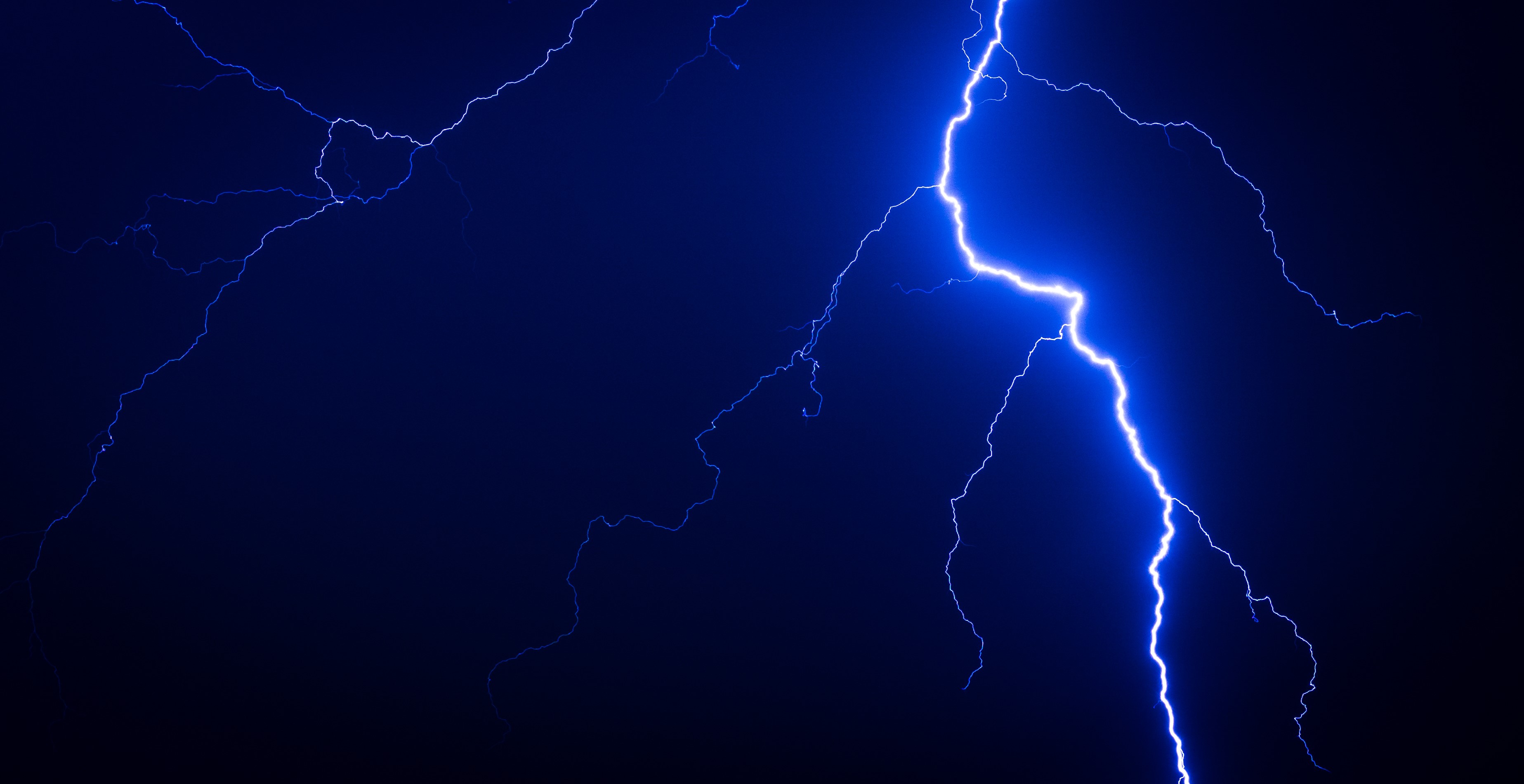 Blue lightning strikes in the dark night sky HD Wallpaper