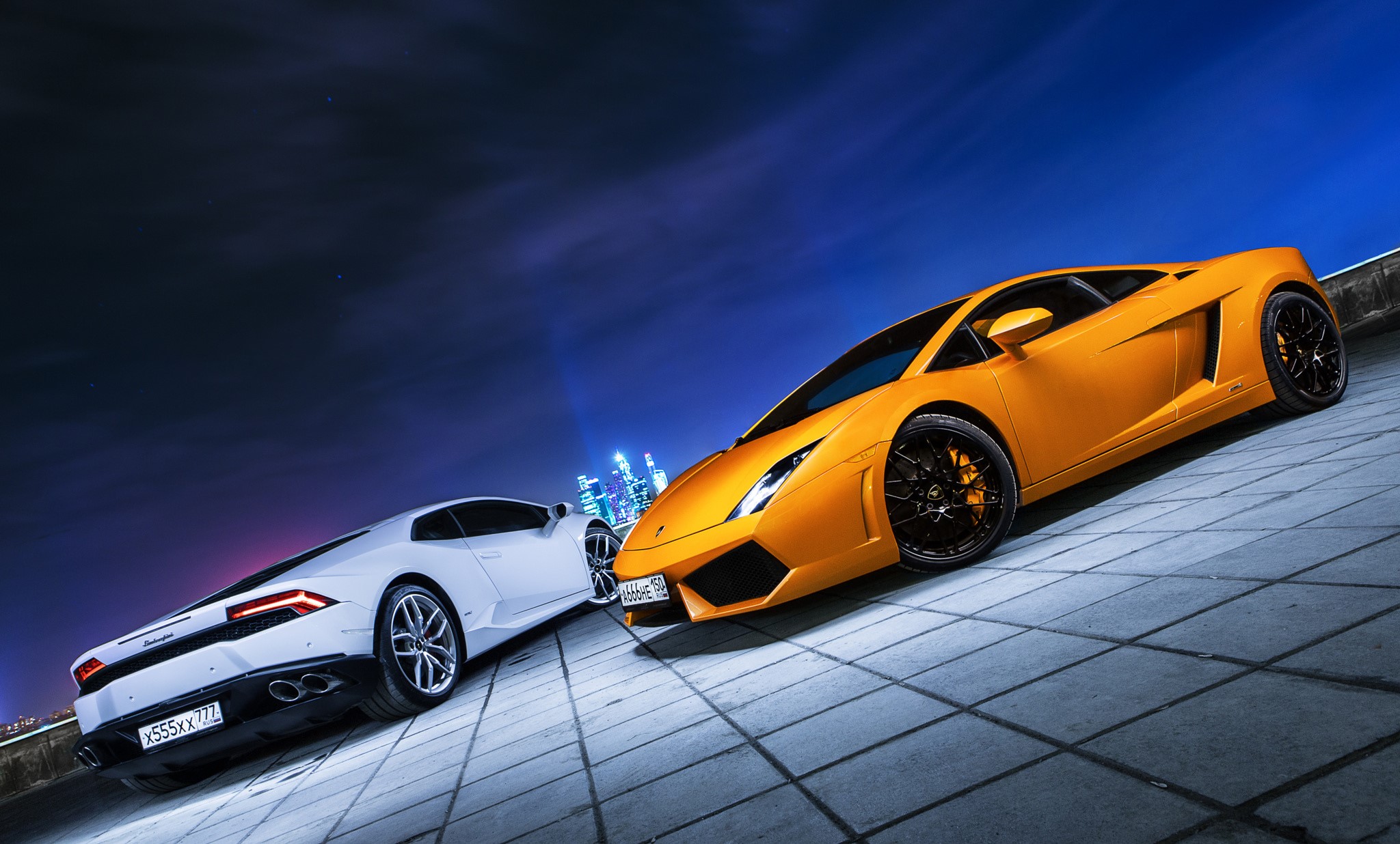 Two Lamborghinis, one white and one yellow, at night HD Wallpaper