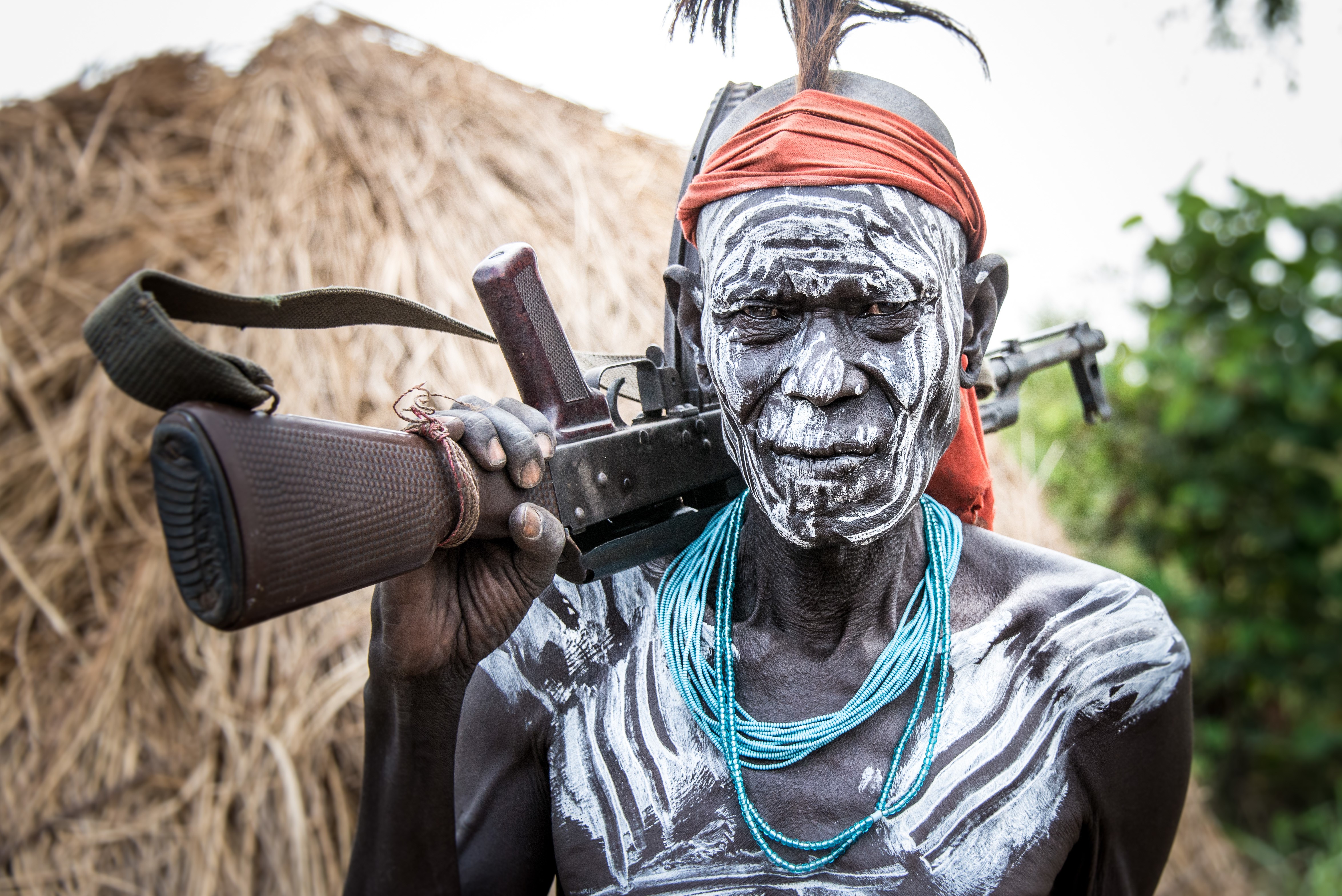 Mursi warrior with assault rifle in Ethiopia HD Wallpaper