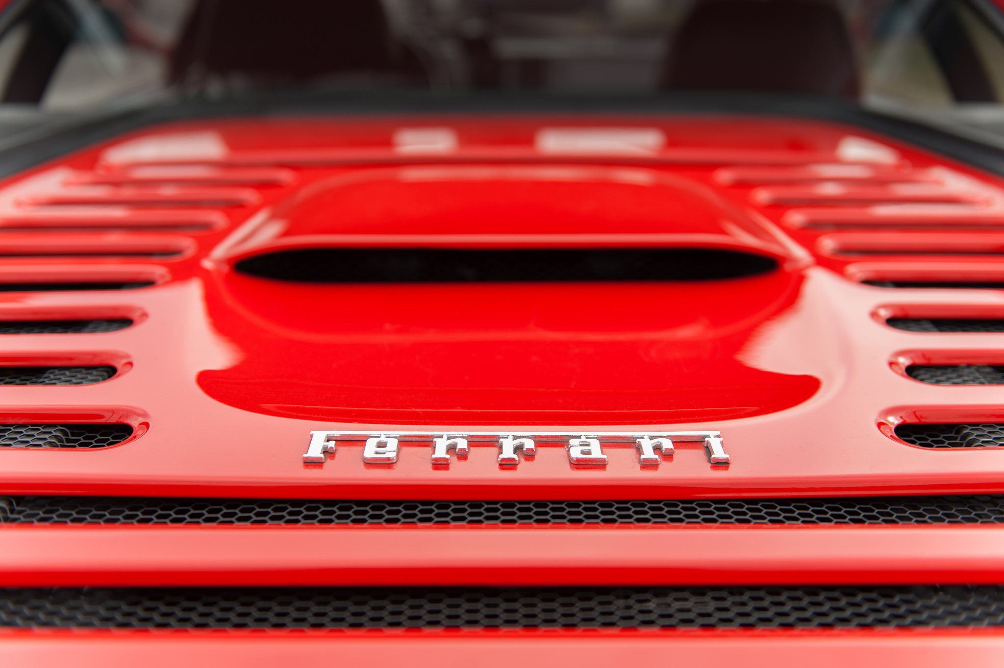 Close-up of a red Ferrari car emblem HD Wallpaper