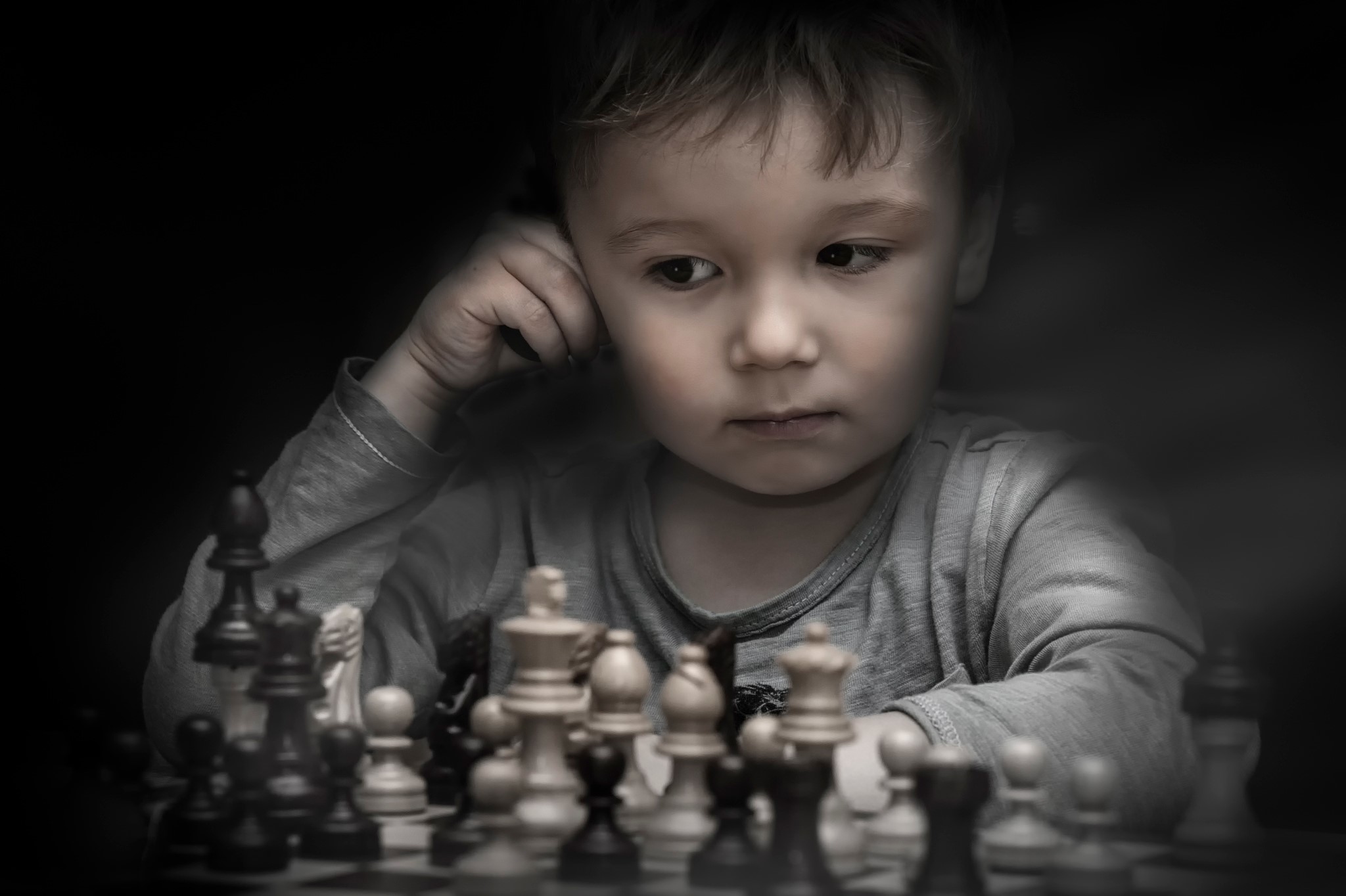 Young boy playing chess HD Wallpaper