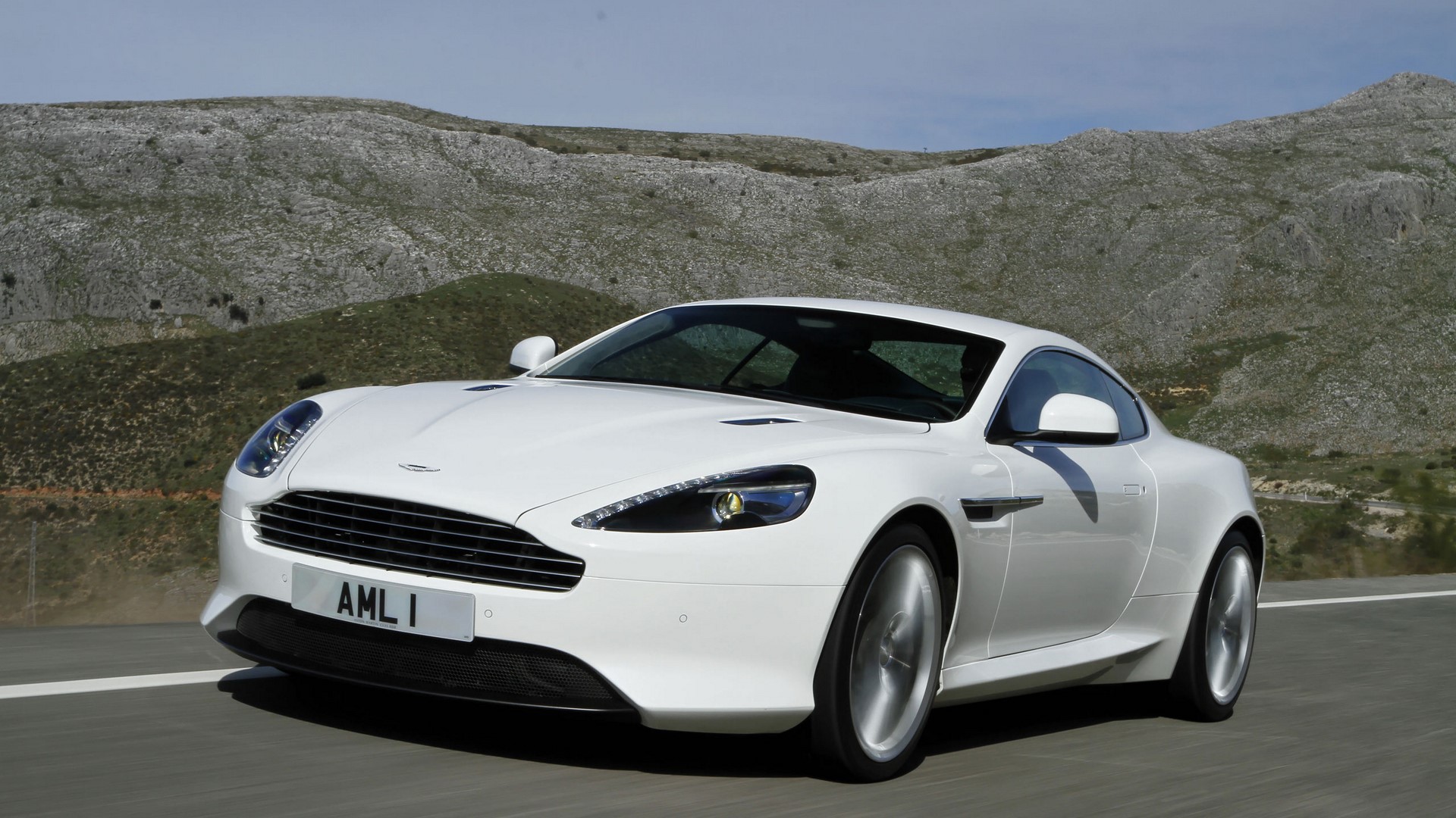 White Aston Martin Virage driving on a road HD Wallpaper