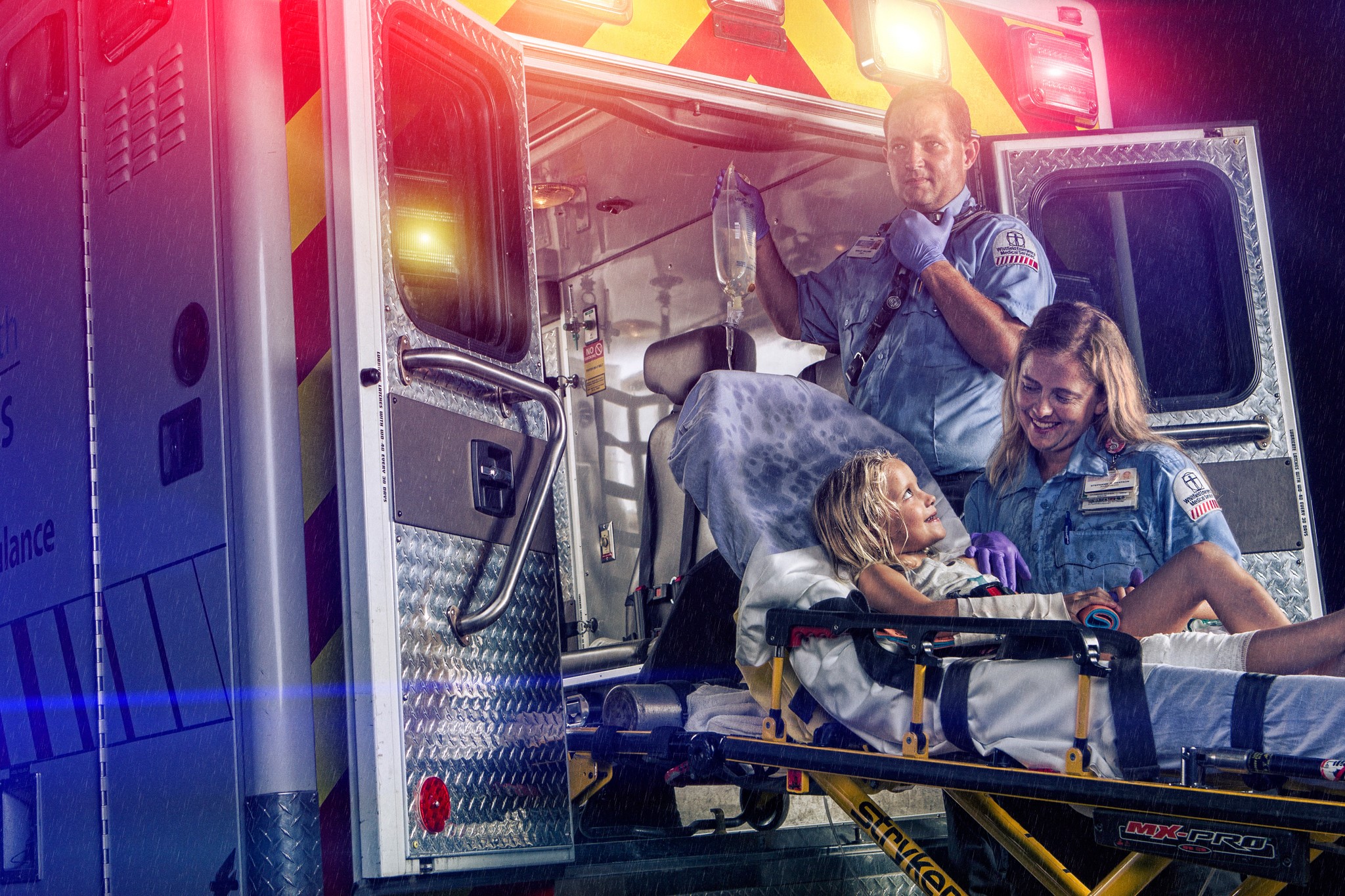 Paramedics with a child in an ambulance HD Wallpaper