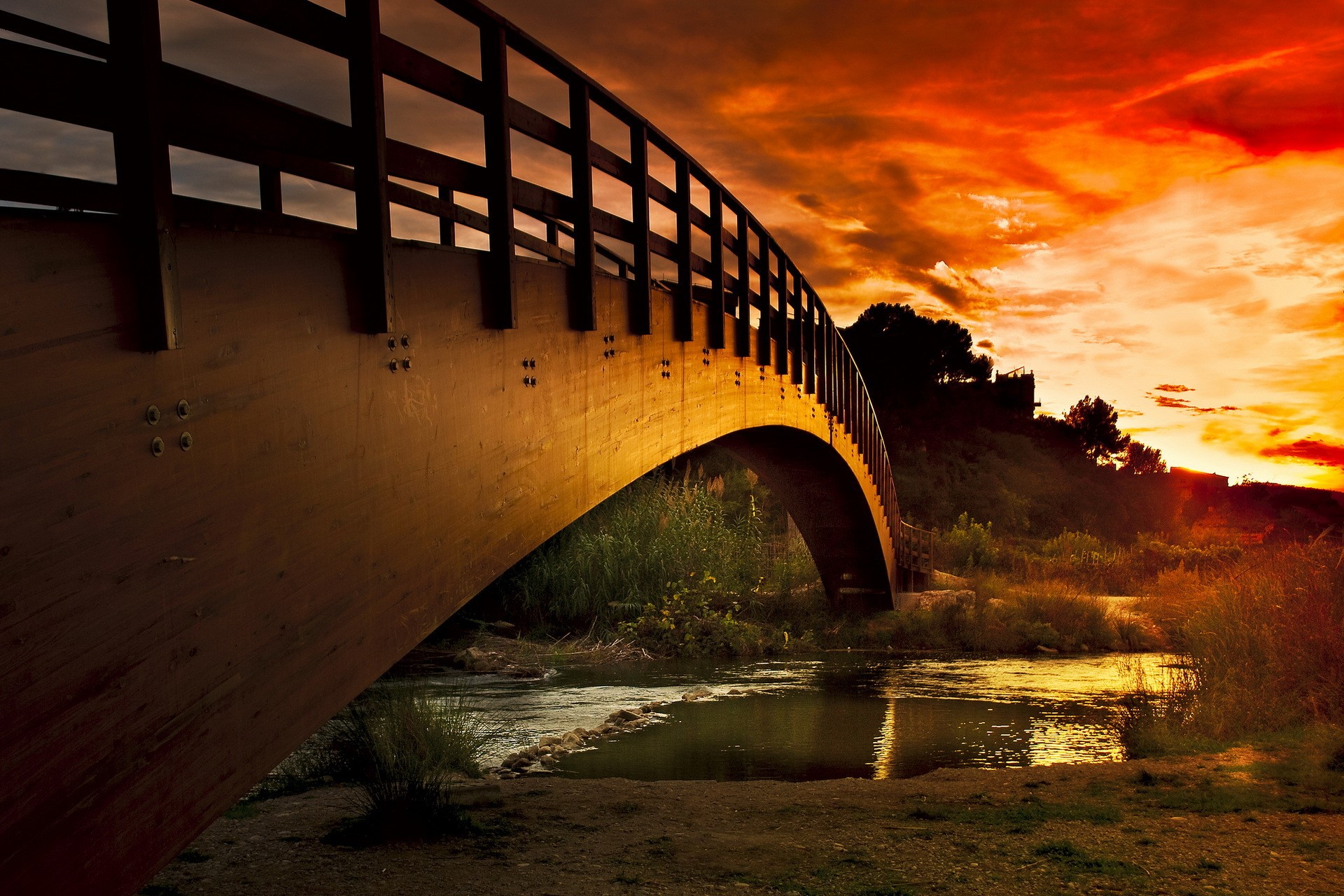 Wooden bridge over a river at sunset HD Wallpaper