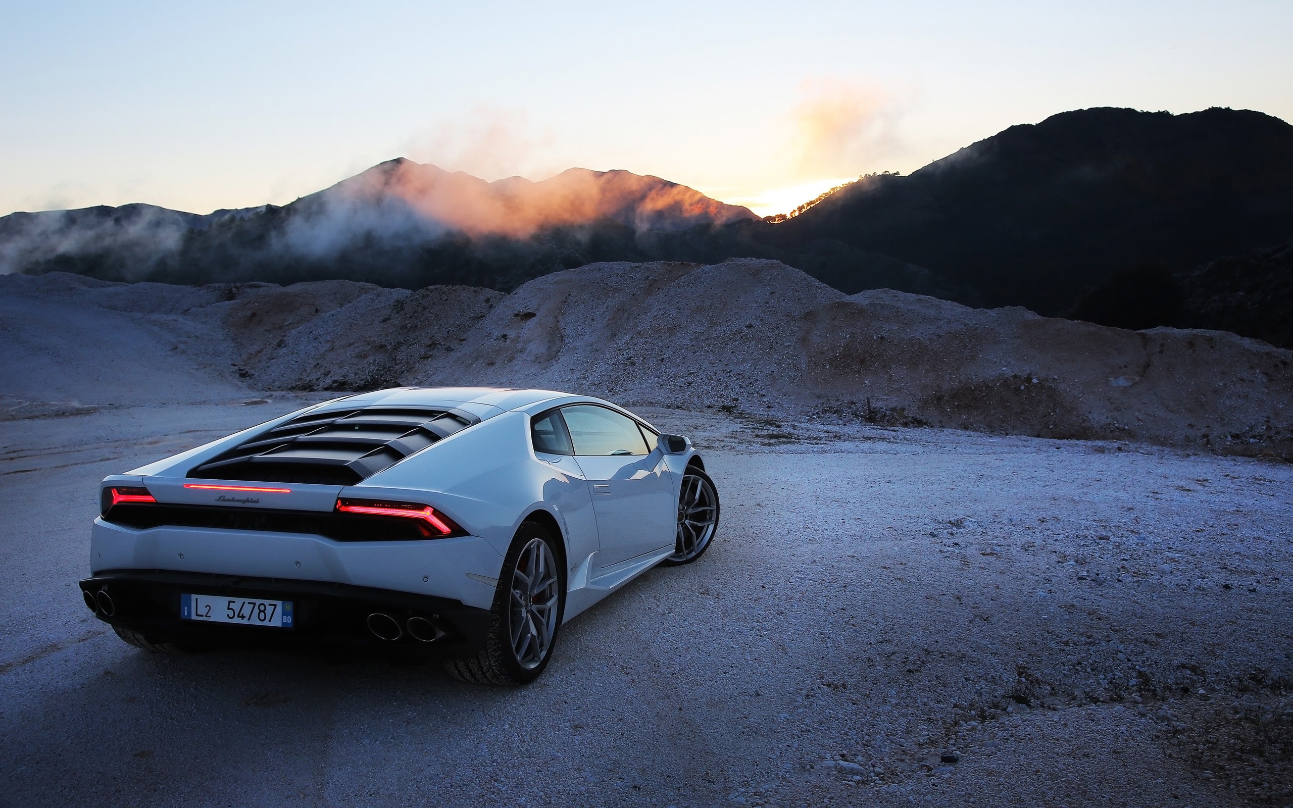 White Lamborghini Huracan parked on gravel road at sunset HD Wallpaper