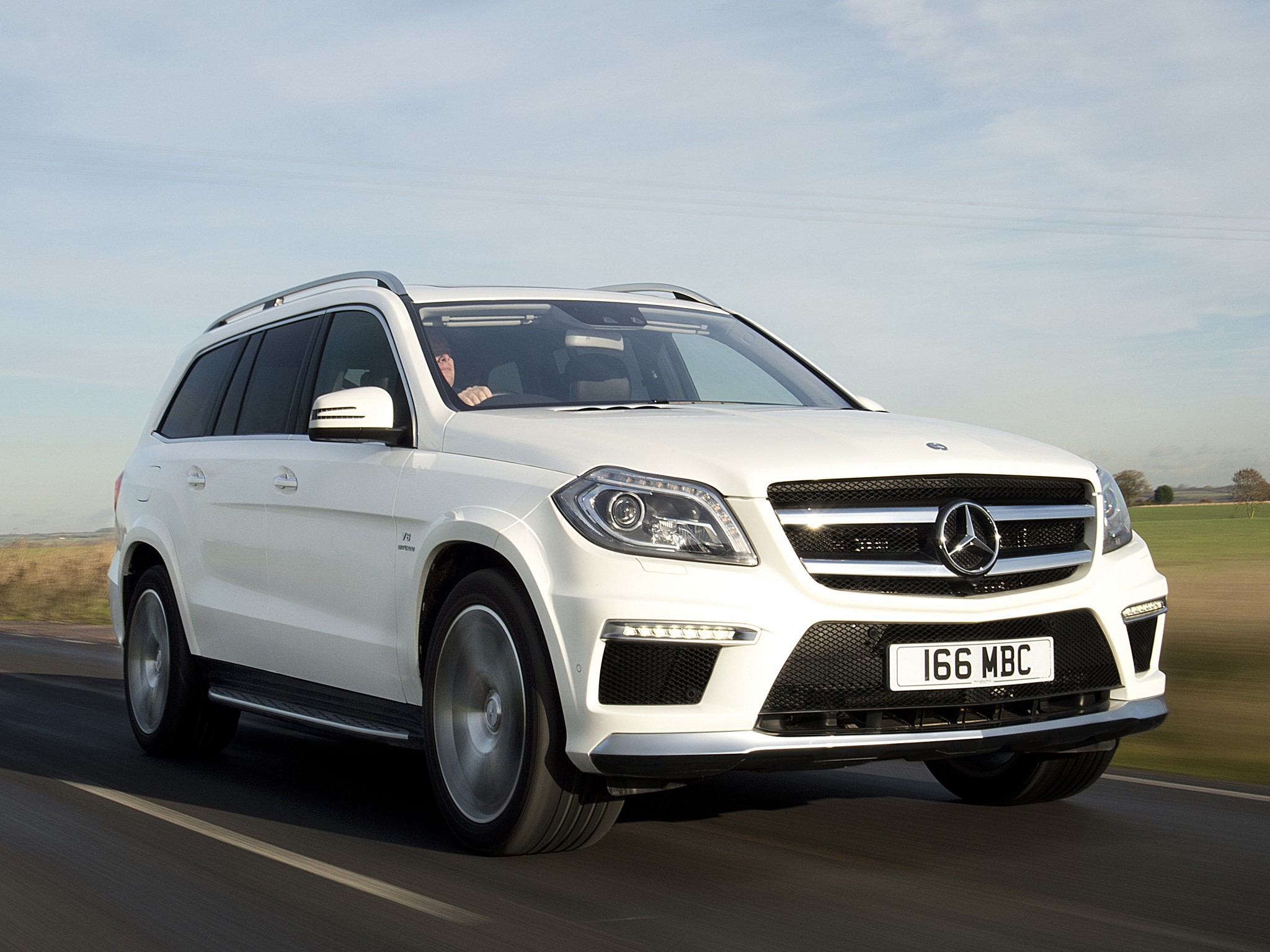 White Mercedes-Benz GL 63 AMG driving on a road HD Wallpaper