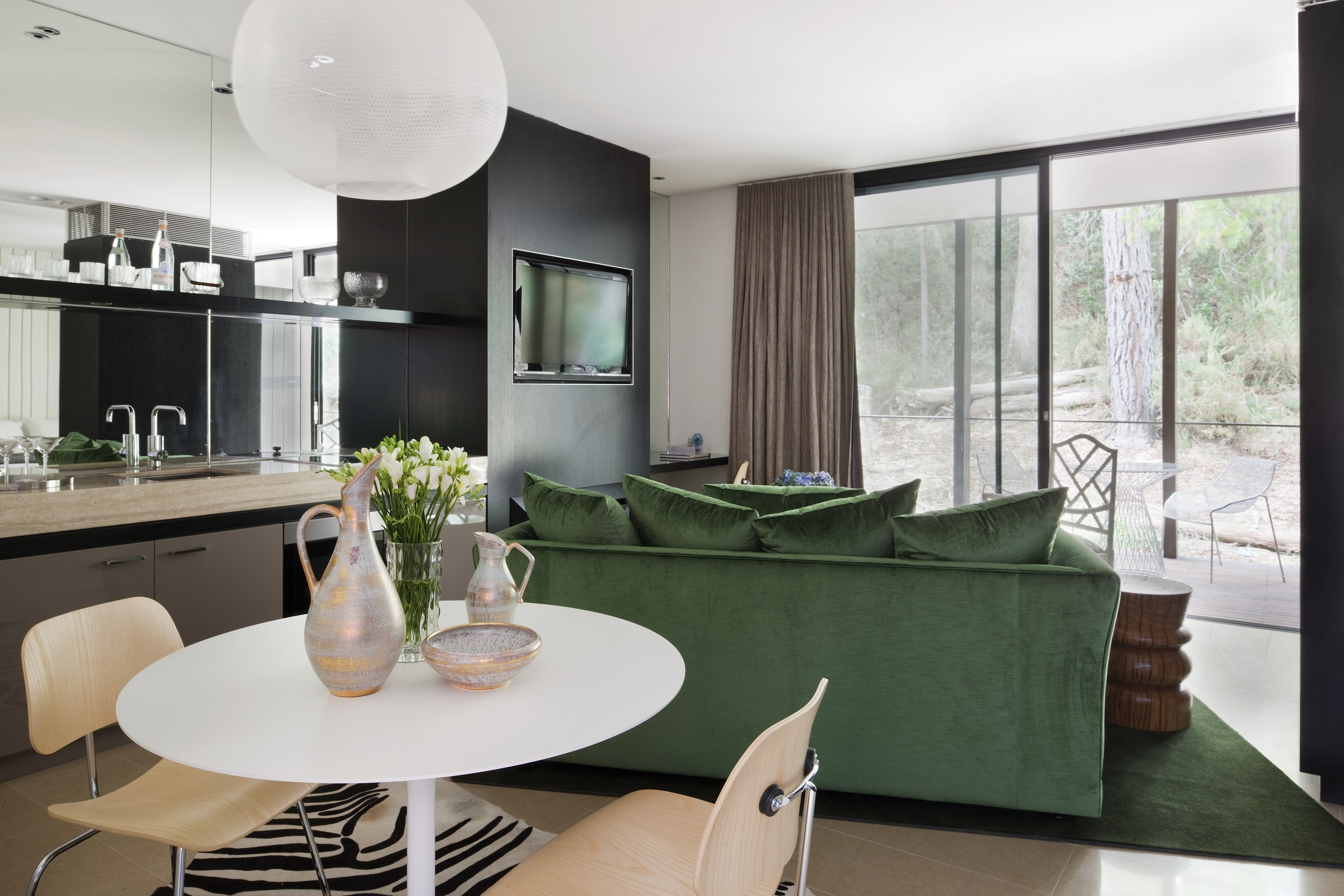 Interior with a green sofa and dining table HD Wallpaper