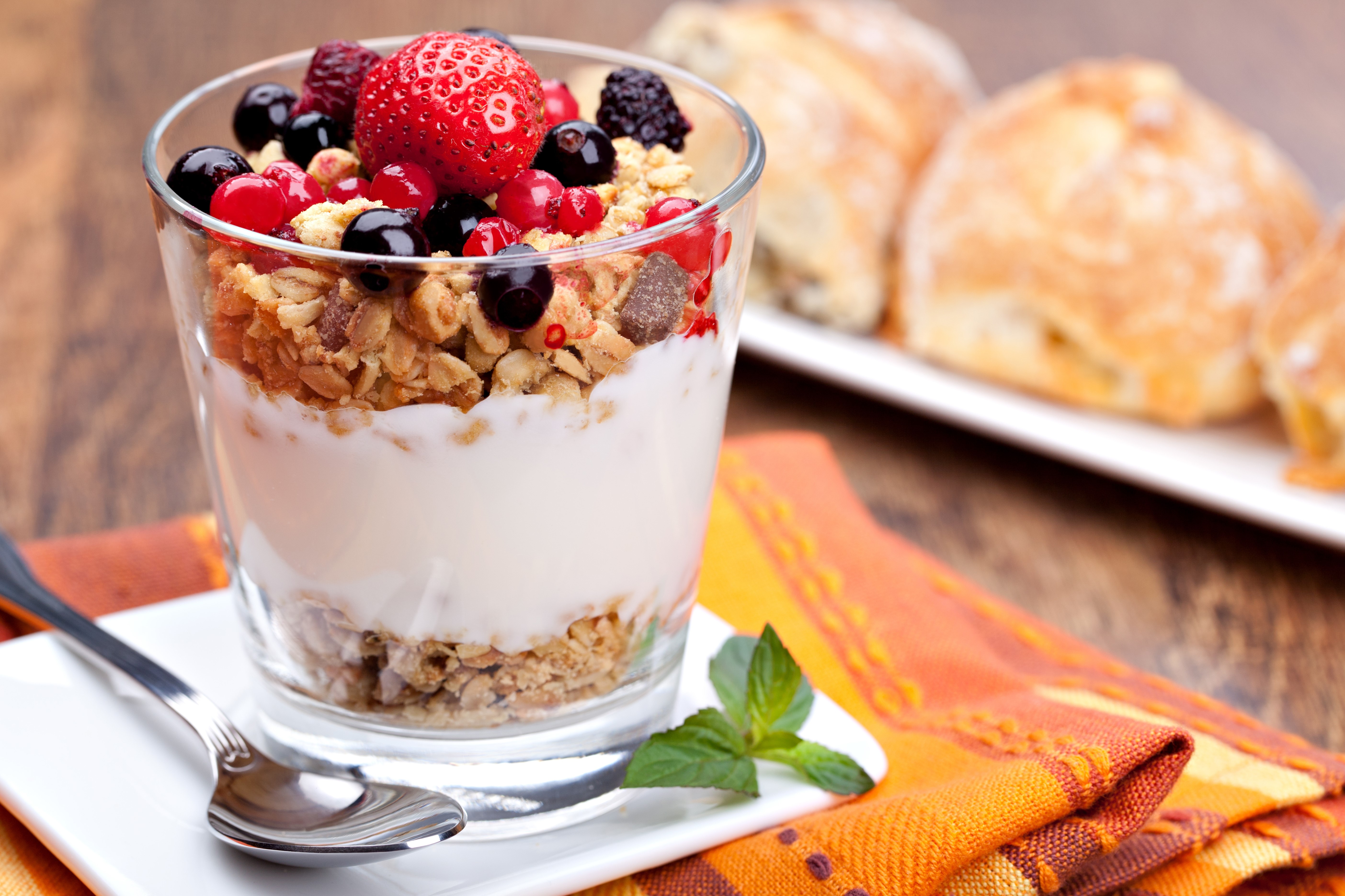 Yogurt parfait with berries and granola in a glass HD Wallpaper