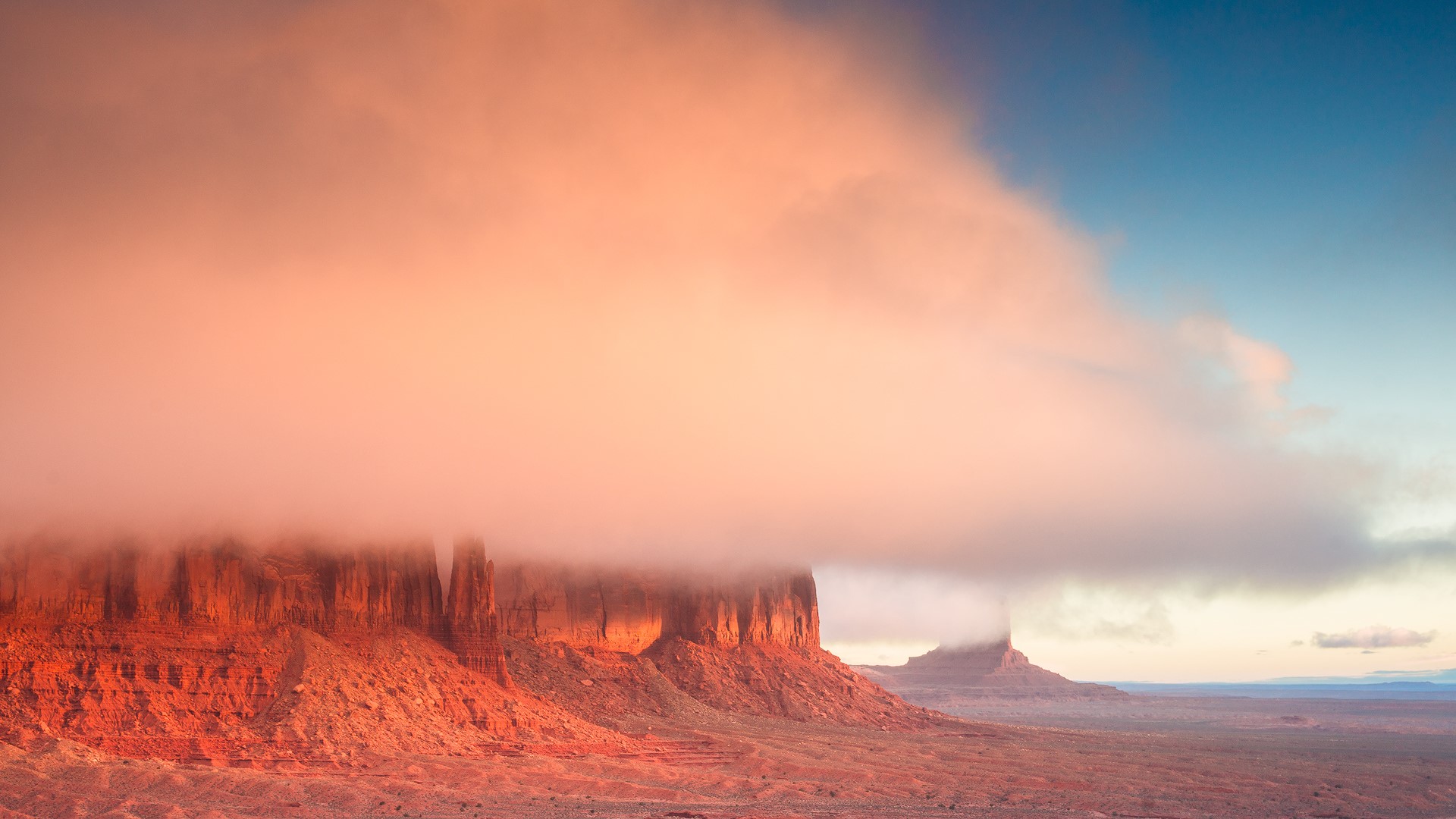 Monument Valley mesas shrouded in fog at sunrise HD Wallpaper