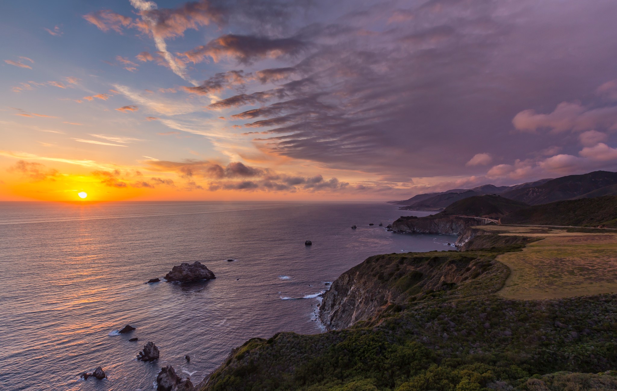 Sunset over the Pacific Ocean coast with mountains HD Wallpaper
