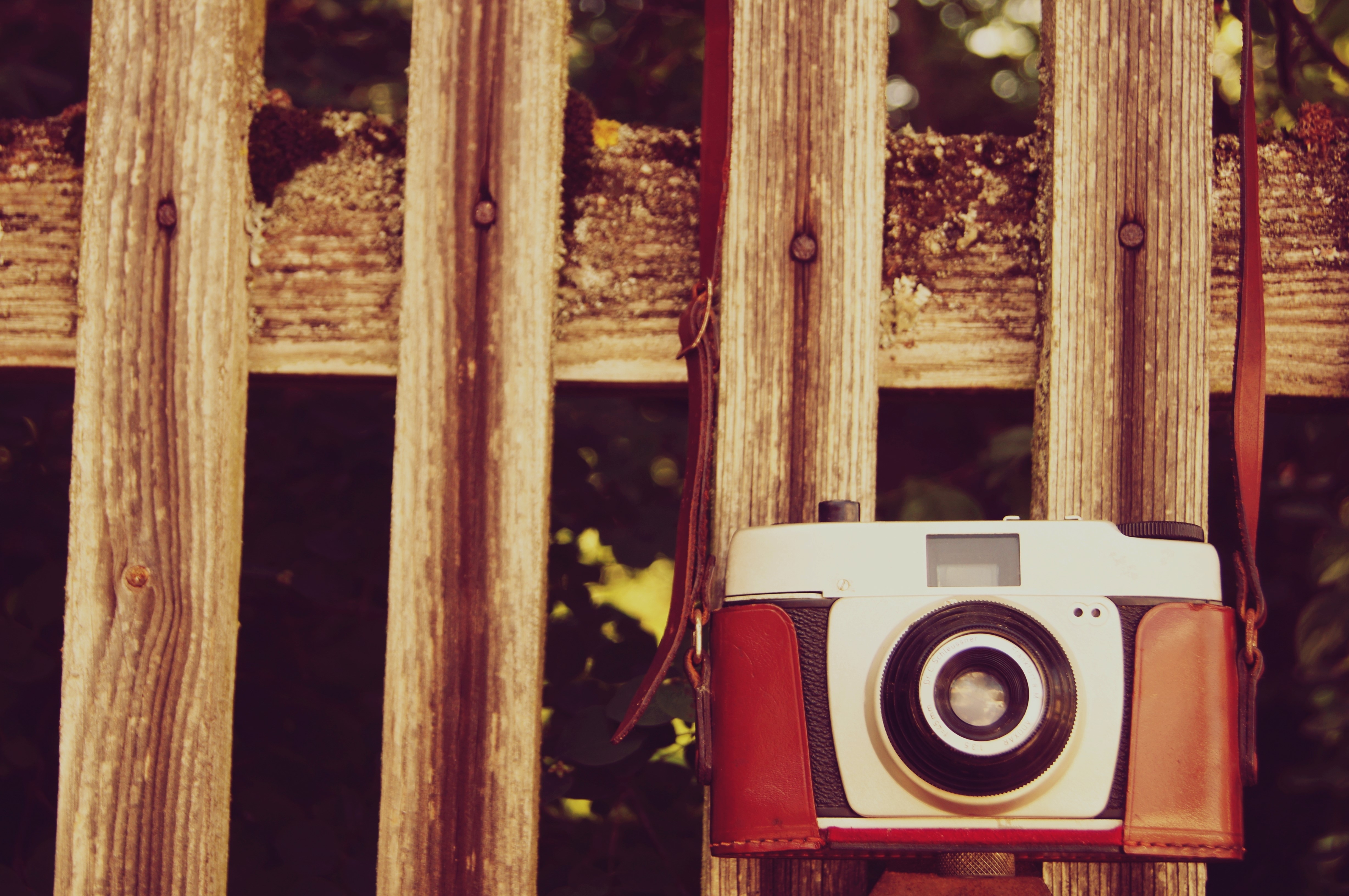Retro camera hanging on a wooden fence HD Wallpaper