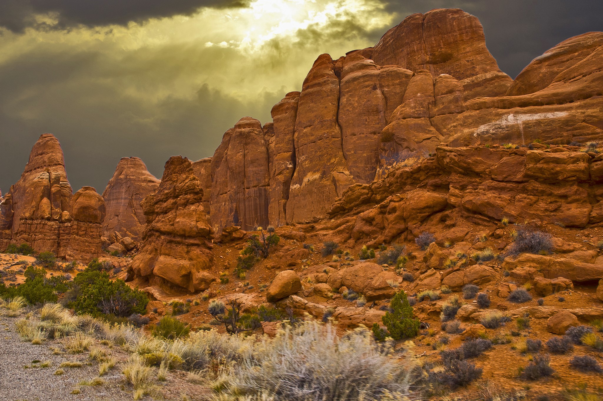 Red rock formations under a stormy sky HD Wallpaper
