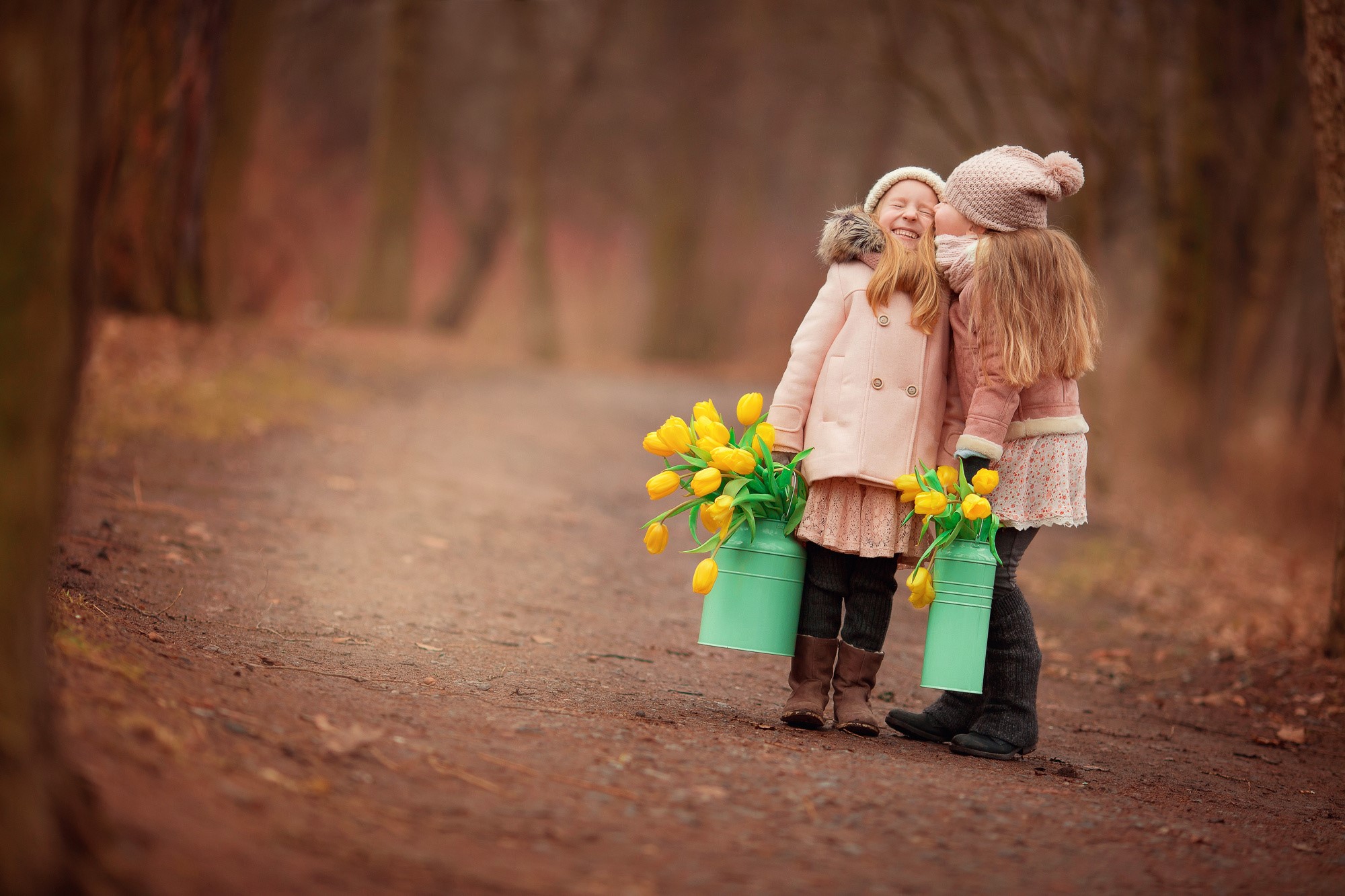Two little girls with tulips in a forest HD Wallpaper