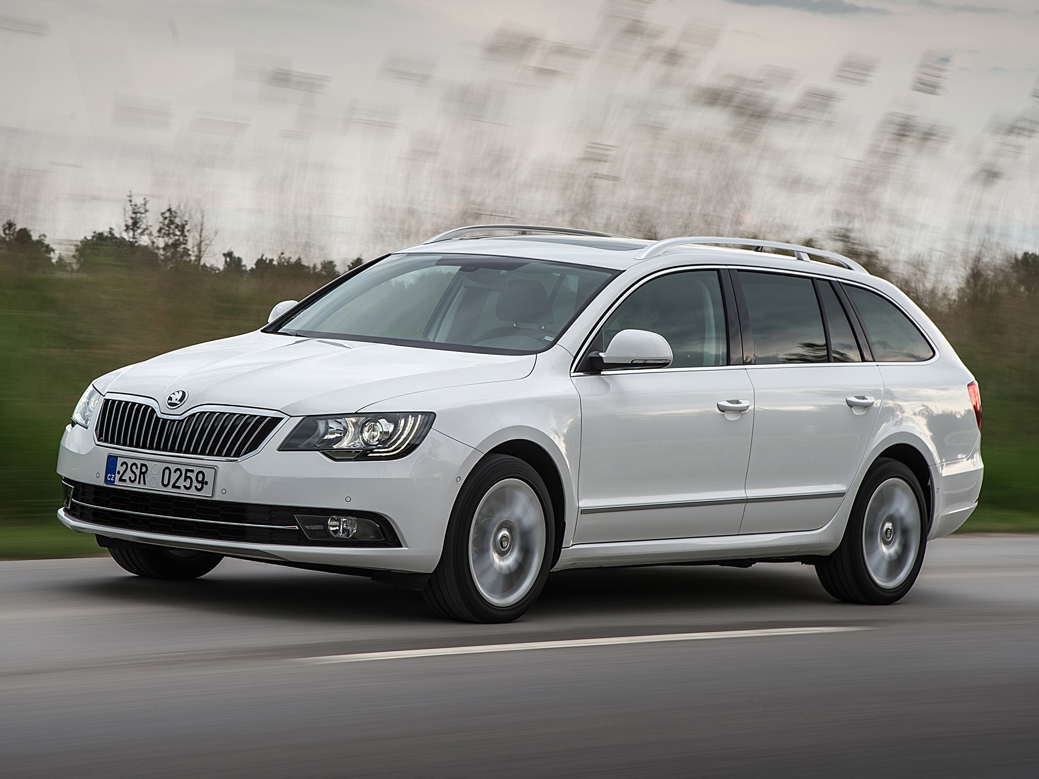 White Skoda Superb Combi driving on a road HD Wallpaper