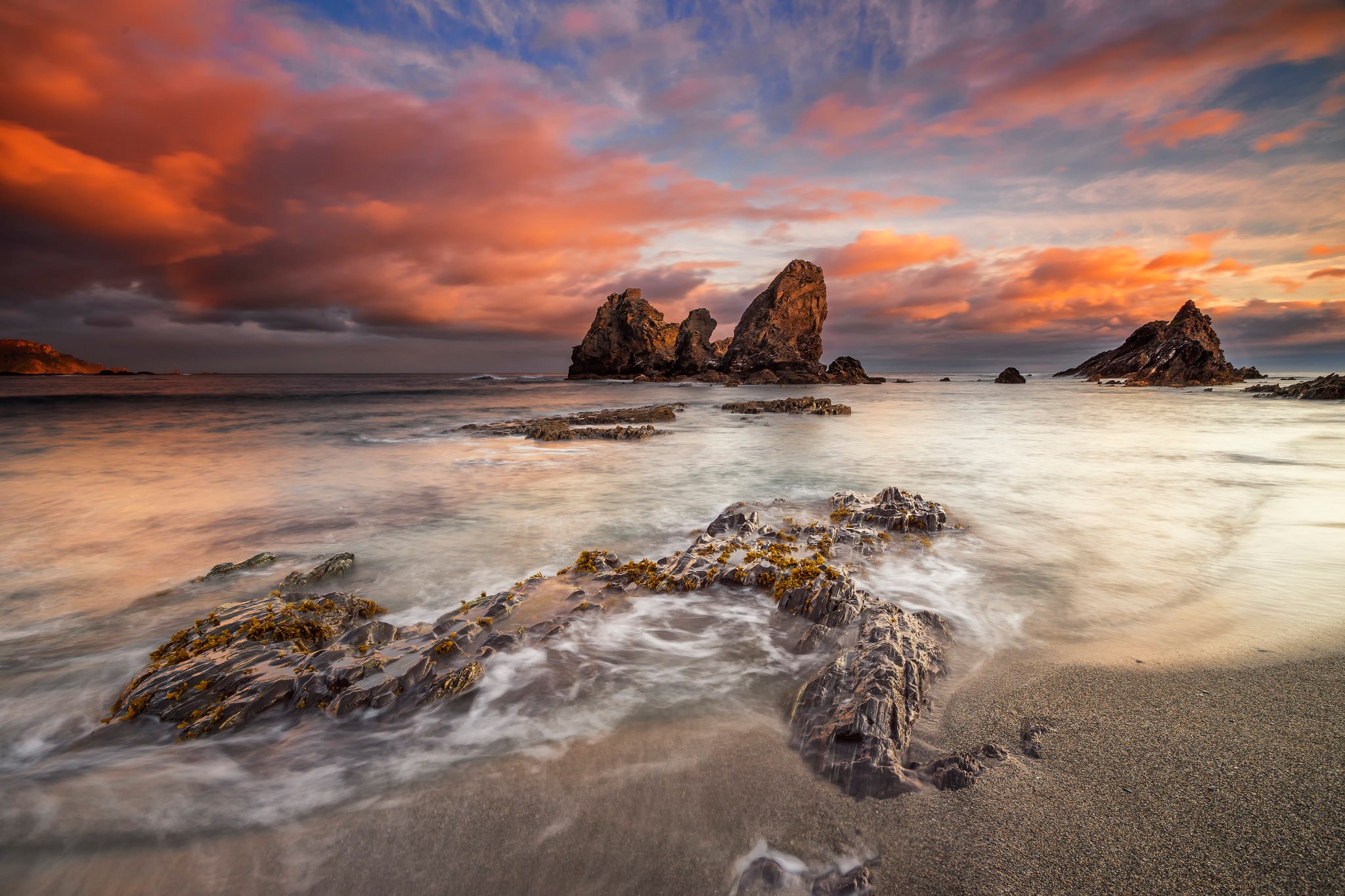 Rocky Coastline at Sunset with Dramatic Clouds HD Wallpaper
